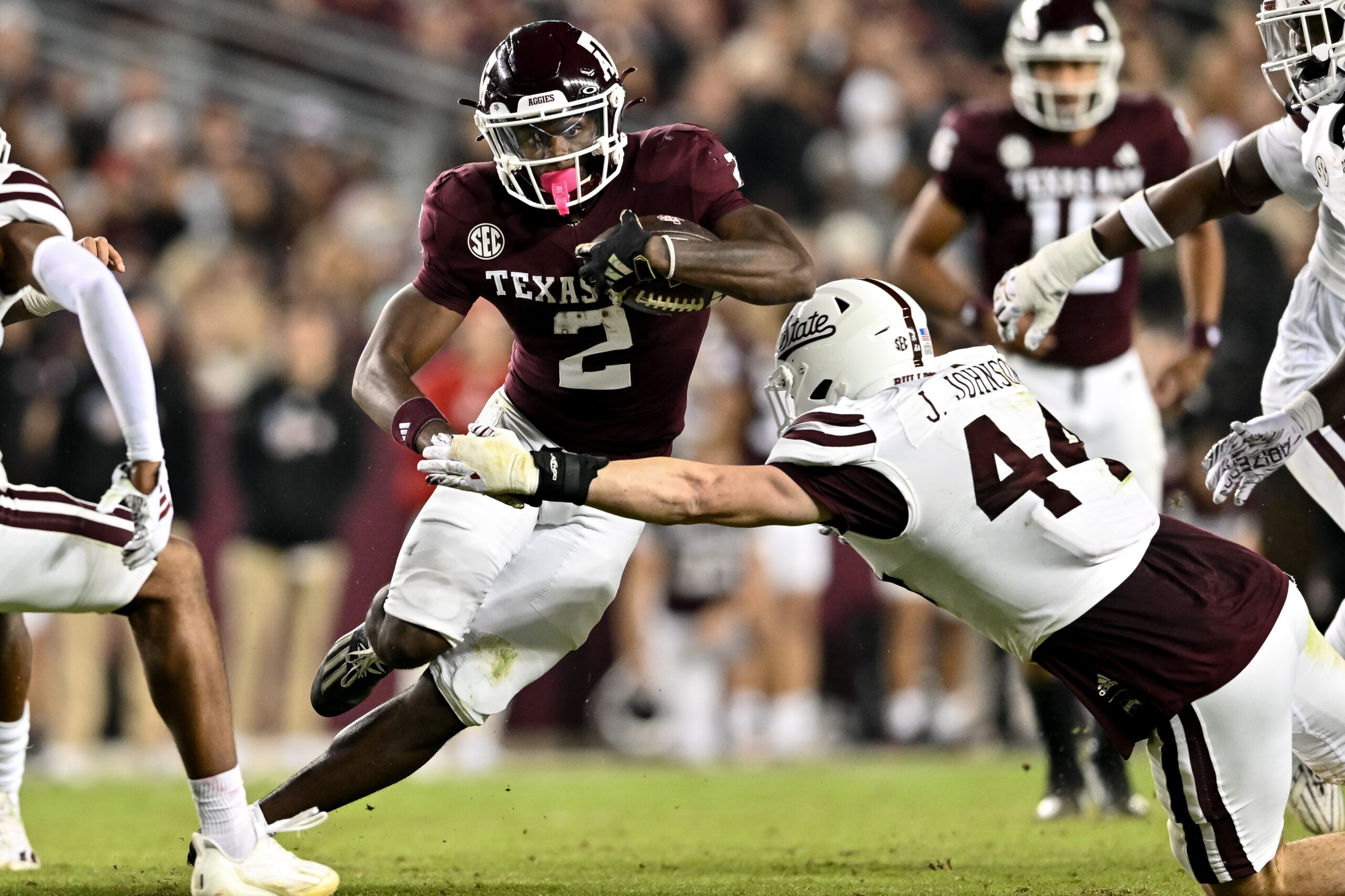 Nov 11, 2023; College Station, Texas, USA; Texas A&M Aggies running back Rueben Owens (2) runs the ball during the second half as Mississippi State Bulldogs linebacker Jett Johnson (44) defends at Kyle Field.
