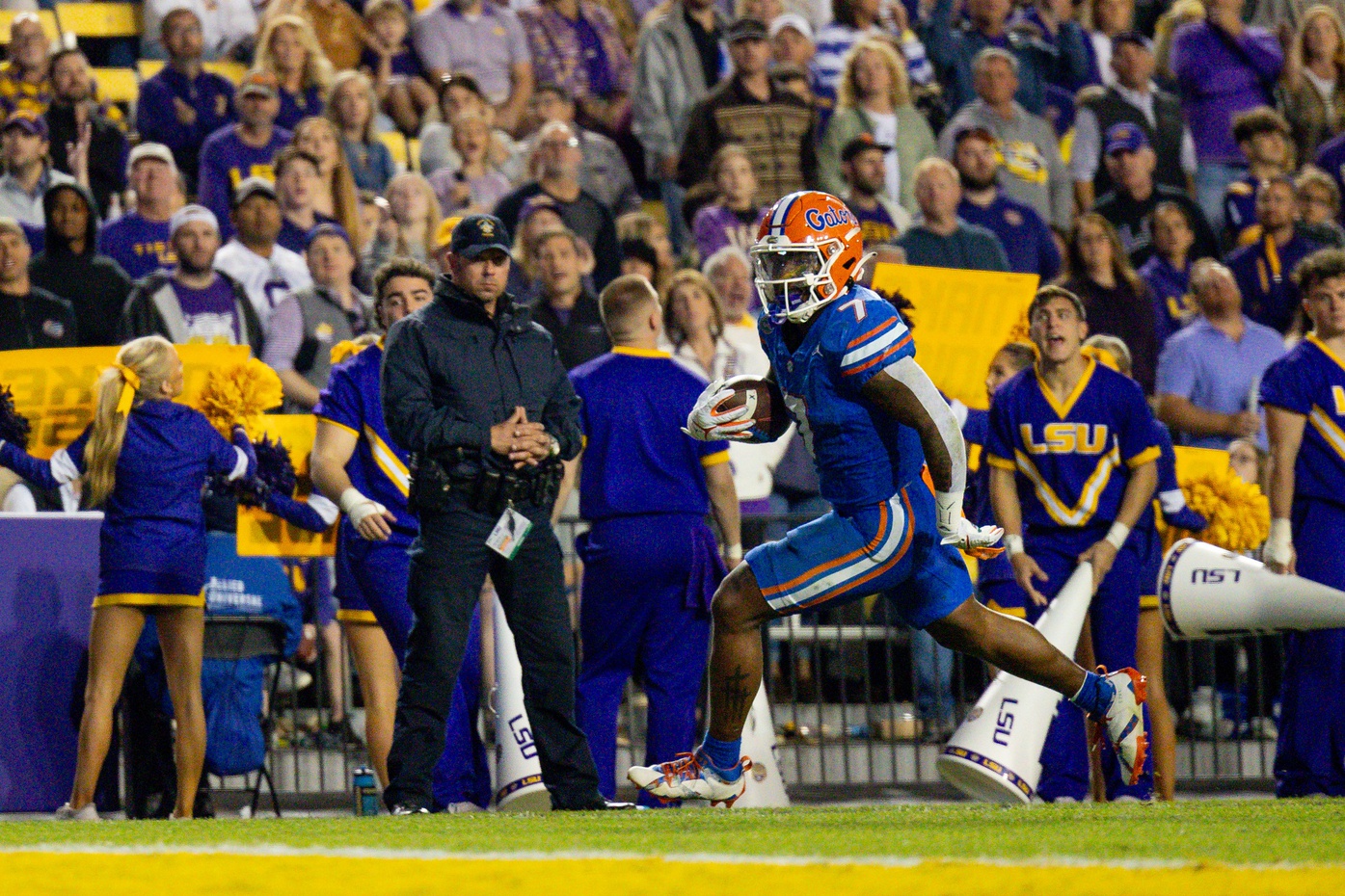 Nov 11, 2023; Baton Rouge, Louisiana, USA; Florida Gators running back Trevor Etienne (7) rushes in for a touchdown against LSU Tigers safety Ryan Yaites (21) during the second half at Tiger Stadium.