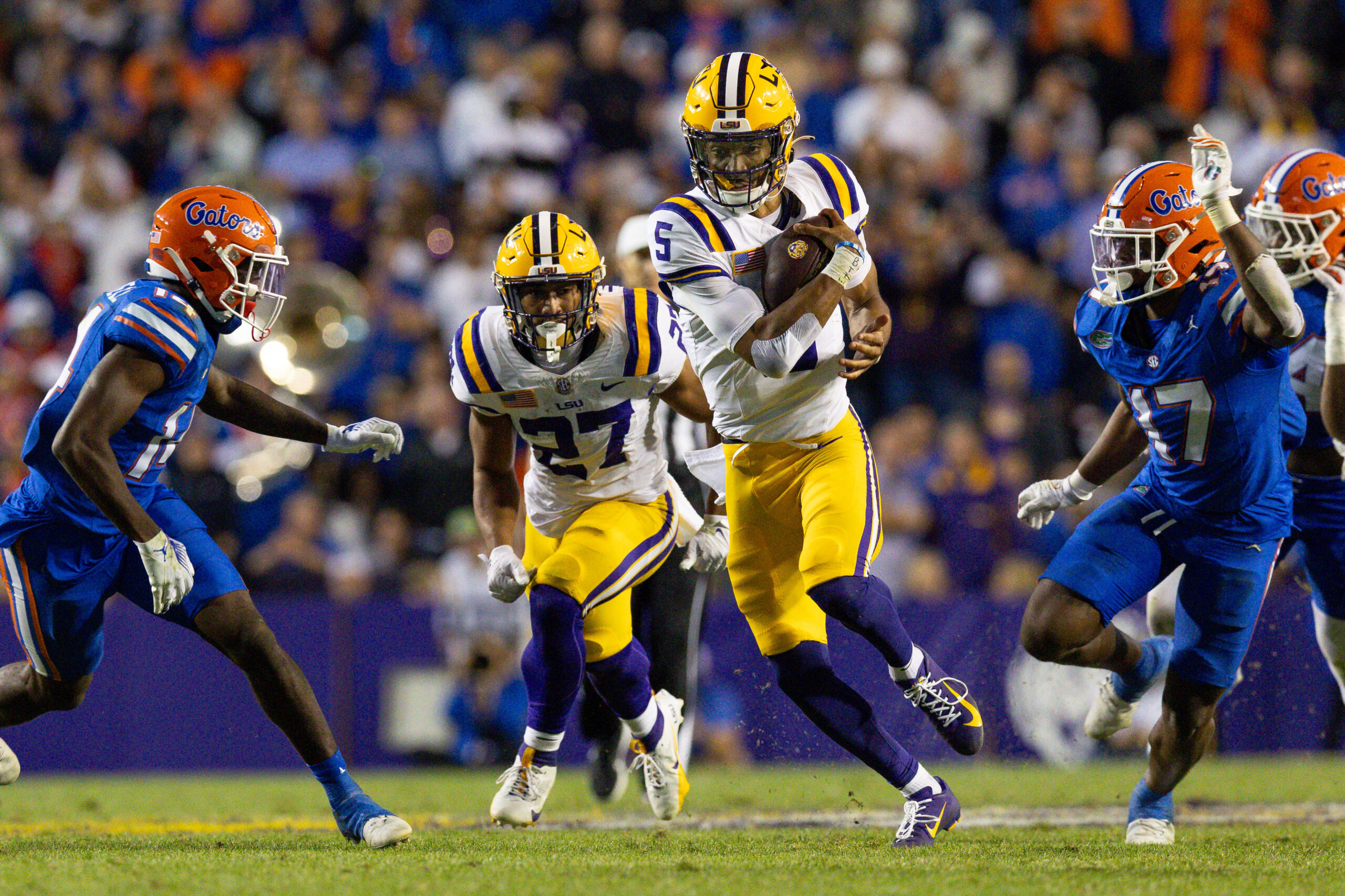 Nov 11, 2023; Baton Rouge, Louisiana, USA; LSU Tigers quarterback Jayden Daniels (5) rushes against the Florida Gators during the second half at Tiger Stadium.