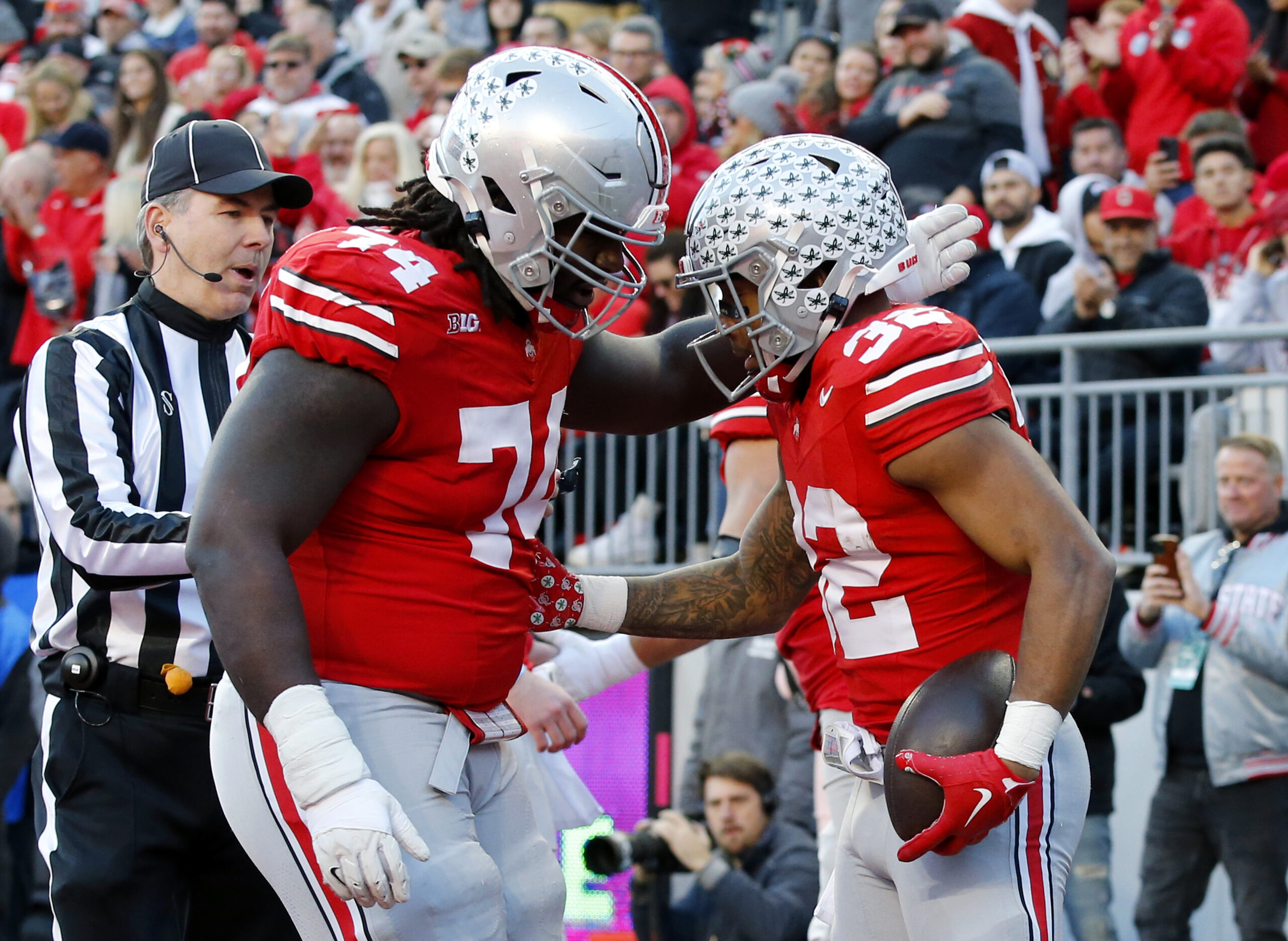 Nov 18, 2023; Columbus, Ohio, USA; Ohio State Buckeyes running back TreVeyon Henderson (32) celebrates his touchdown run with offensive lineman Donovan Jackson (74) during the first quarter against the Minnesota Golden Gophers at Ohio Stadium. Mandatory Credit: Joseph Maiorana-USA TODAY Sports