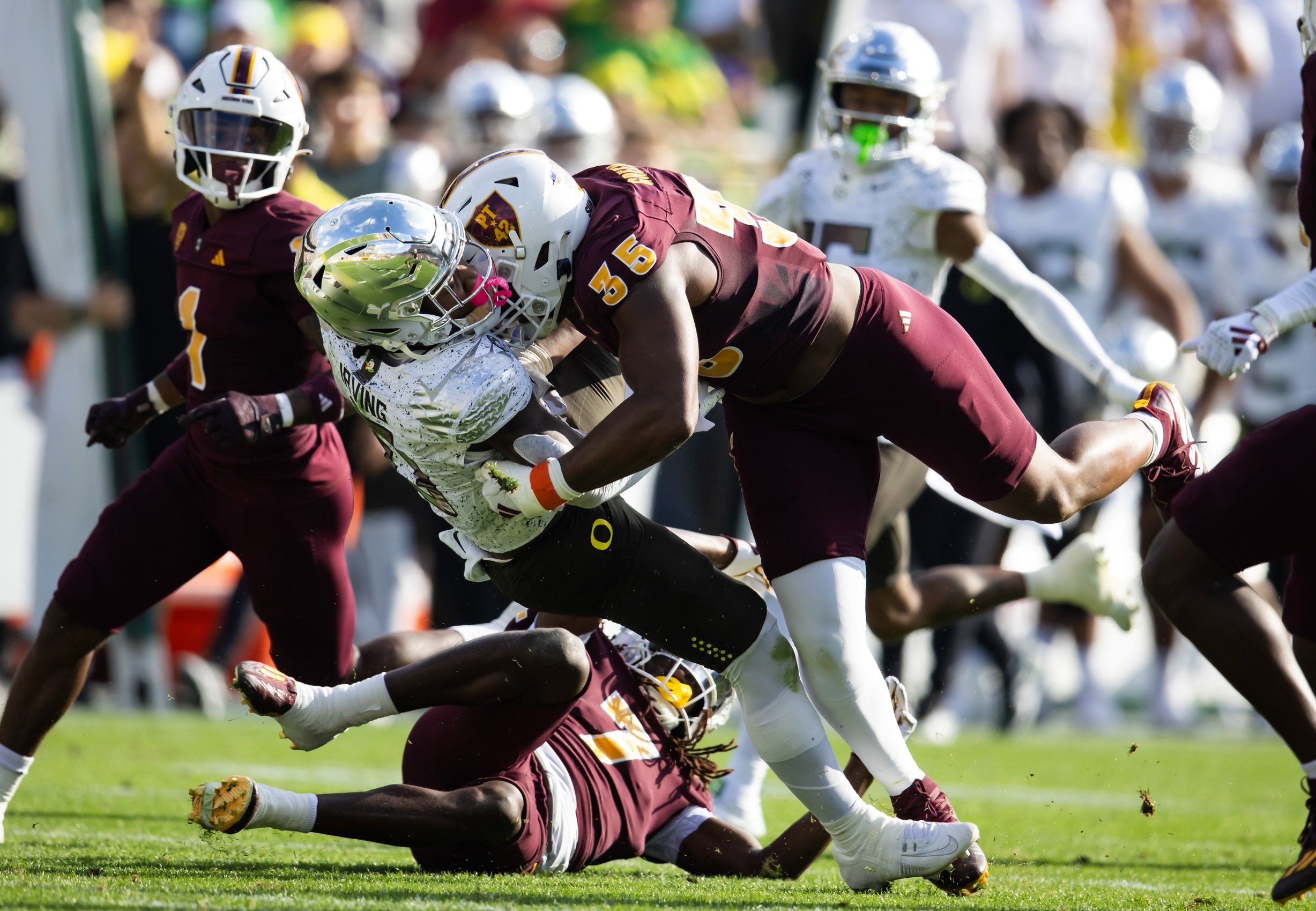 Nov 18, 2023; Tempe, Arizona, USA; Oregon Ducks running back Bucky Irving (0) is tackled by Arizona State Sun Devils defensive lineman B.J. Green II (35) in the first half at Mountain America Stadium.