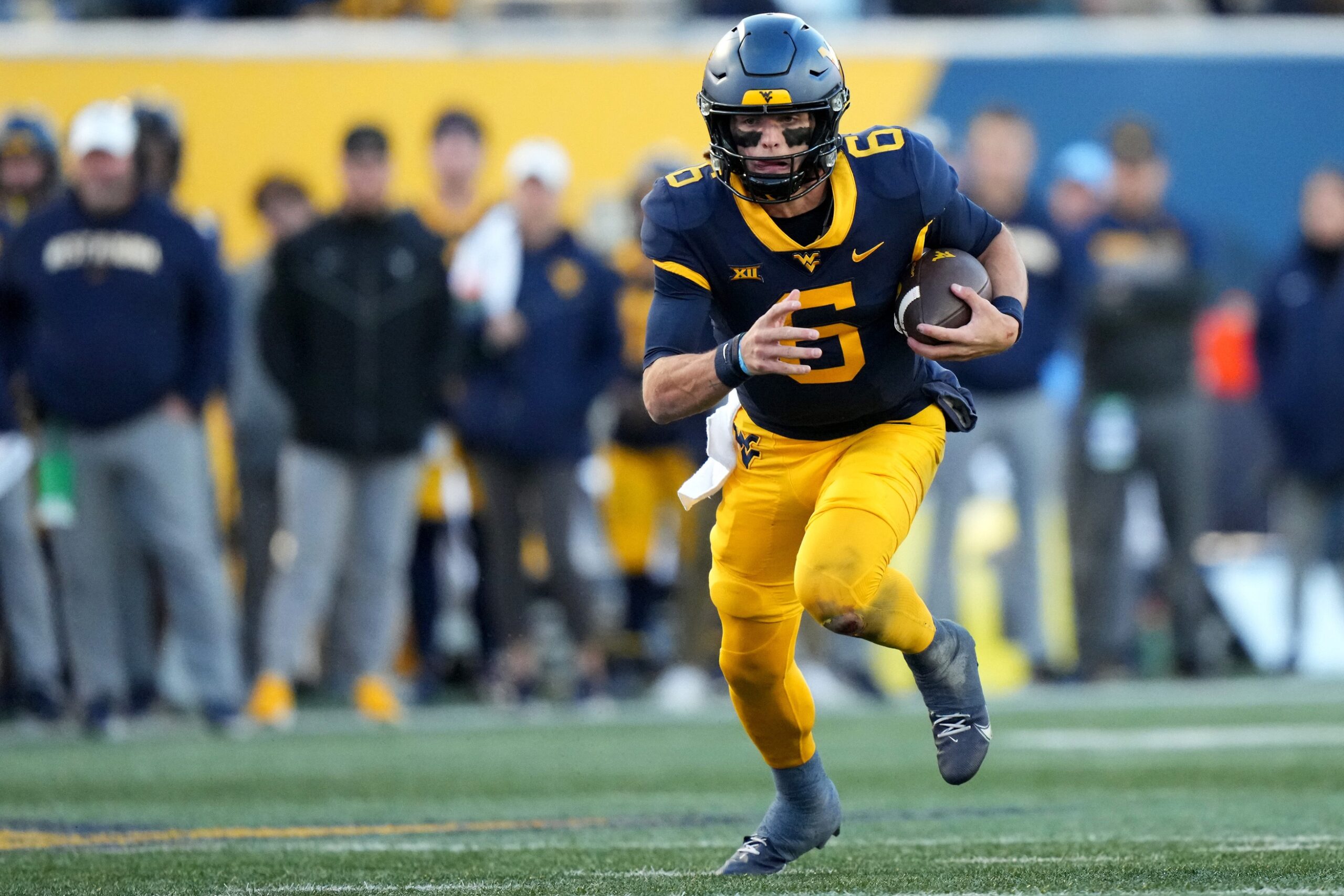 West Virginia Mountaineers quarterback Garrett Greene (6) carries the ball on a touchdown run in the third quarter during an NCAA college football game between the Cincinnati Bearcats and the West Virginia Mountaineers, Saturday, Nov. 18, 2023, at Milan Puskar Stadium in Morgantown, W. Va. The West Virginia Mountaineers won, 42-21.
