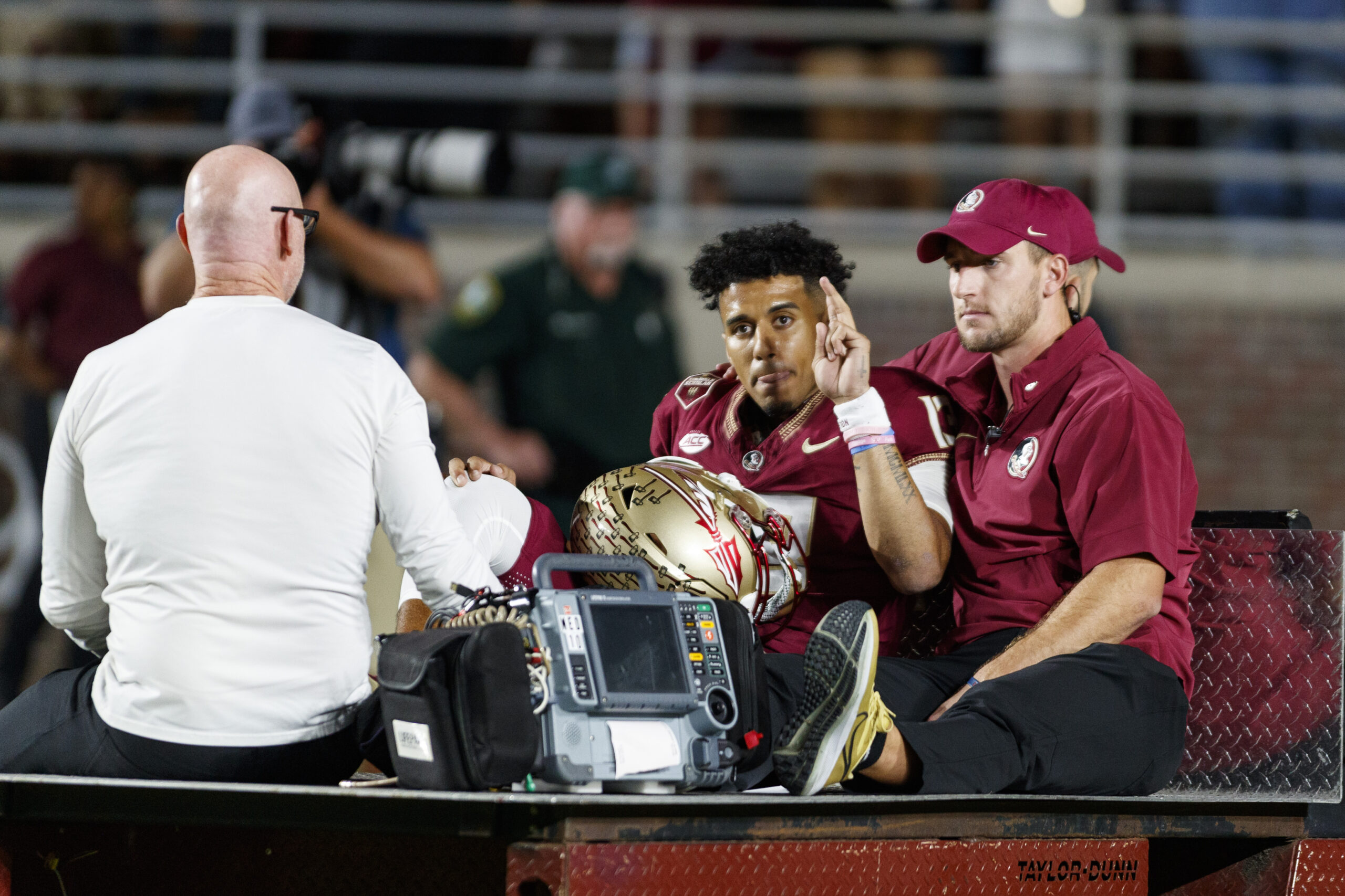Nov 18, 2023; Tallahassee, Florida, USA; Florida State Seminoles quarterback Jordan Travis (13) waves to fans while being carted off after an injury against the North Alabama Lions during the first quarter at Doak S. Campbell Stadium.