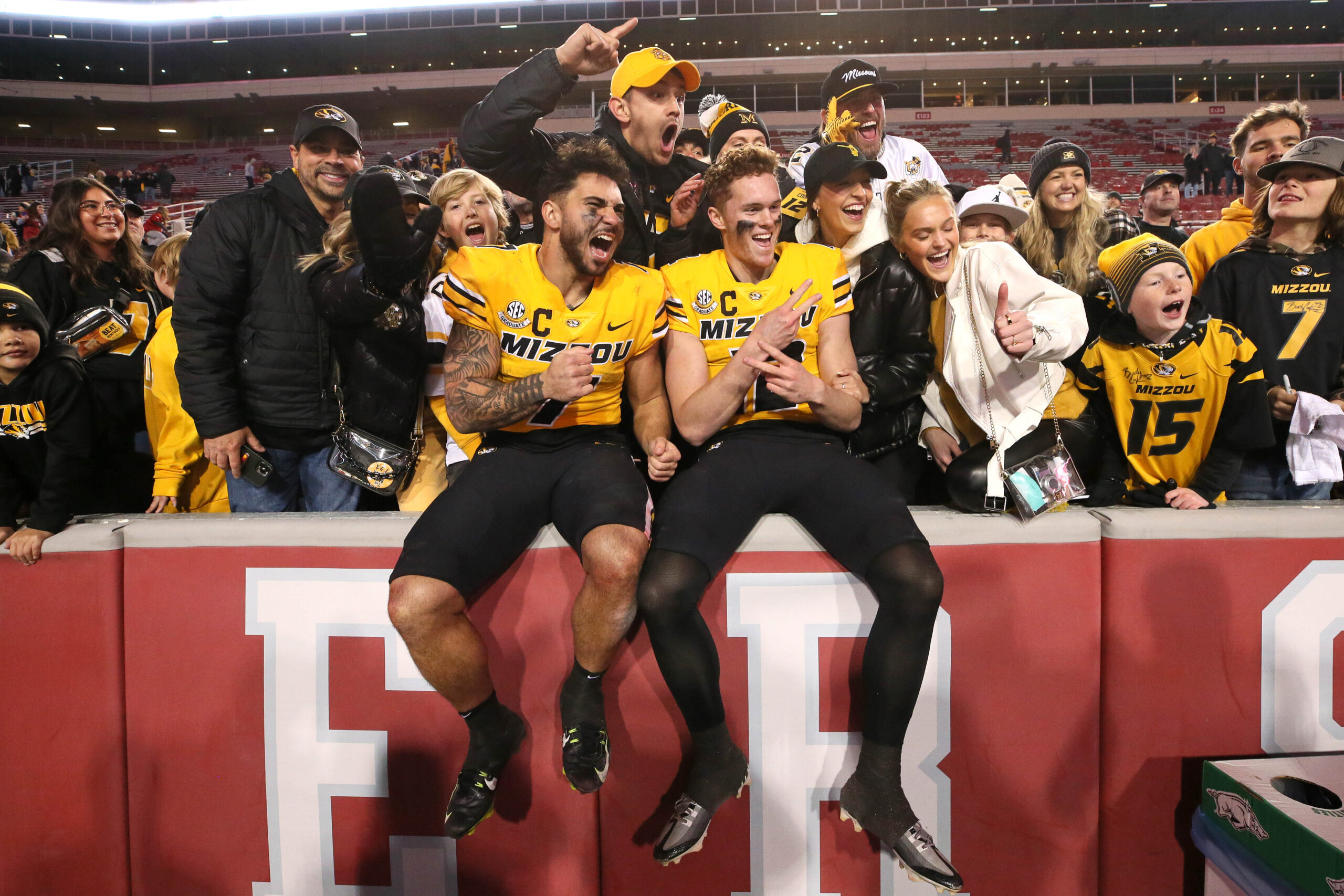 Nov 24, 2023; Fayetteville, Arkansas, USA; Missouri Tigers running back Cody Schrader (7) and quarterback Brady Cook (12) pose with fans after the game against the Arkansas Razorbacks at Donald W. Reynolds Razorback Stadium. Missouri won 48-14.