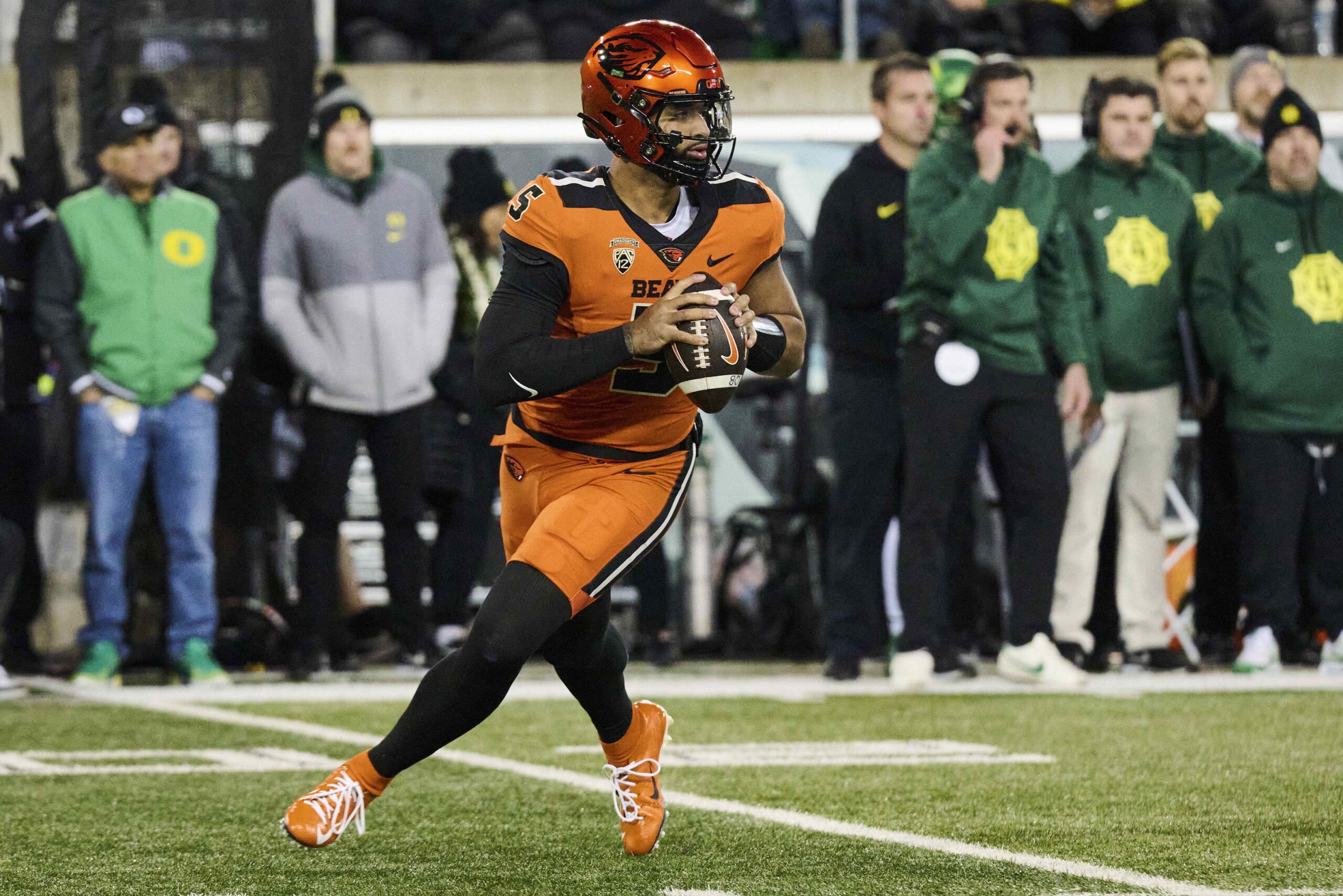 Nov 24, 2023; Eugene, Oregon, USA; Oregon State Beavers quarterback DJ Uiagalelei (5) rolls out to pass the ball during the first half against the Oregon Ducks at Autzen Stadium.