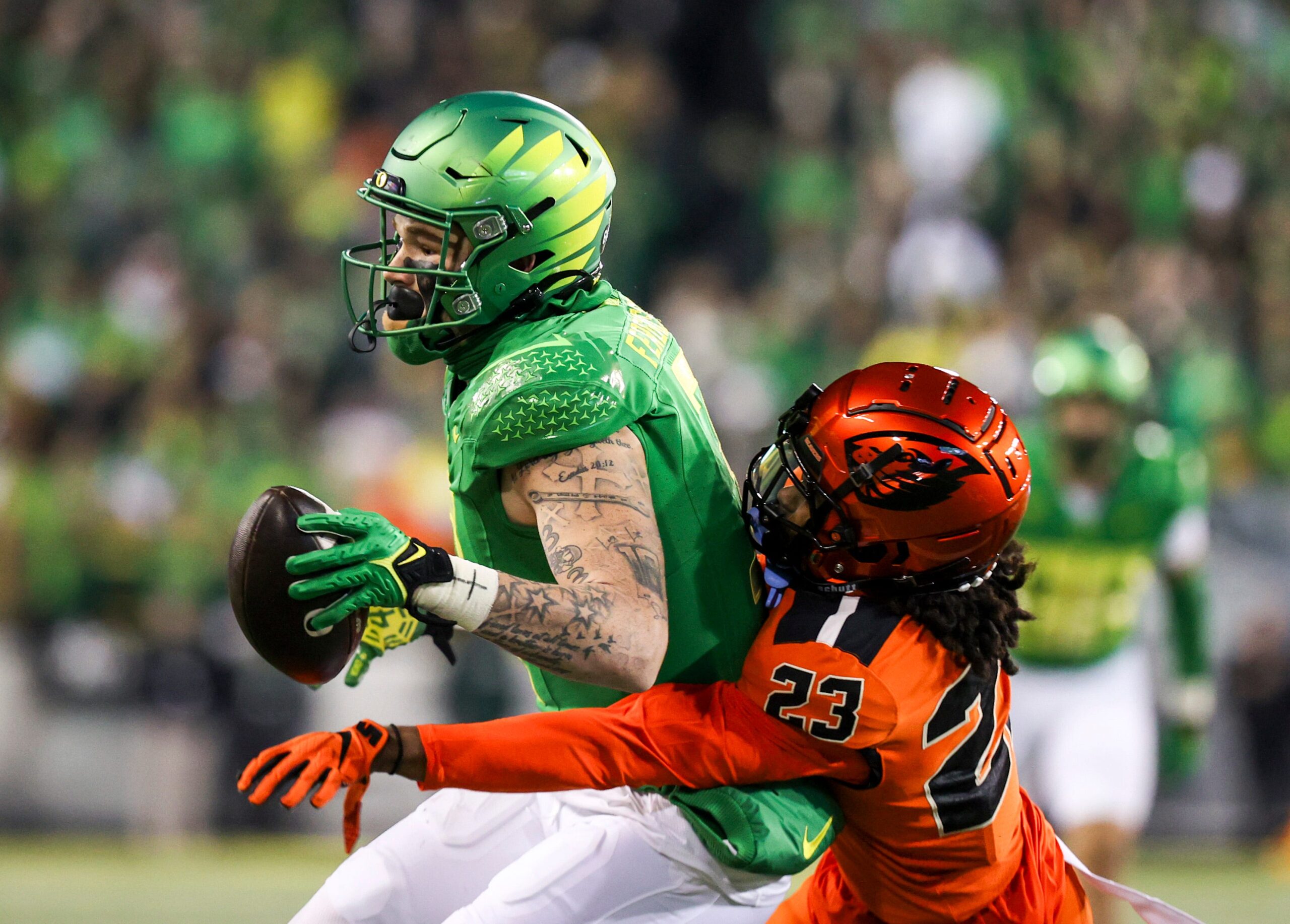 Oregon Ducks tight end Terrance Ferguson catches a pass as he s brought down by Oregon State Beavers defensive back Jermod McCoy during the first half of the annual rivalry game on Friday, Nov. 24, 2023 at Autzen Stadium in Eugene, Ore.