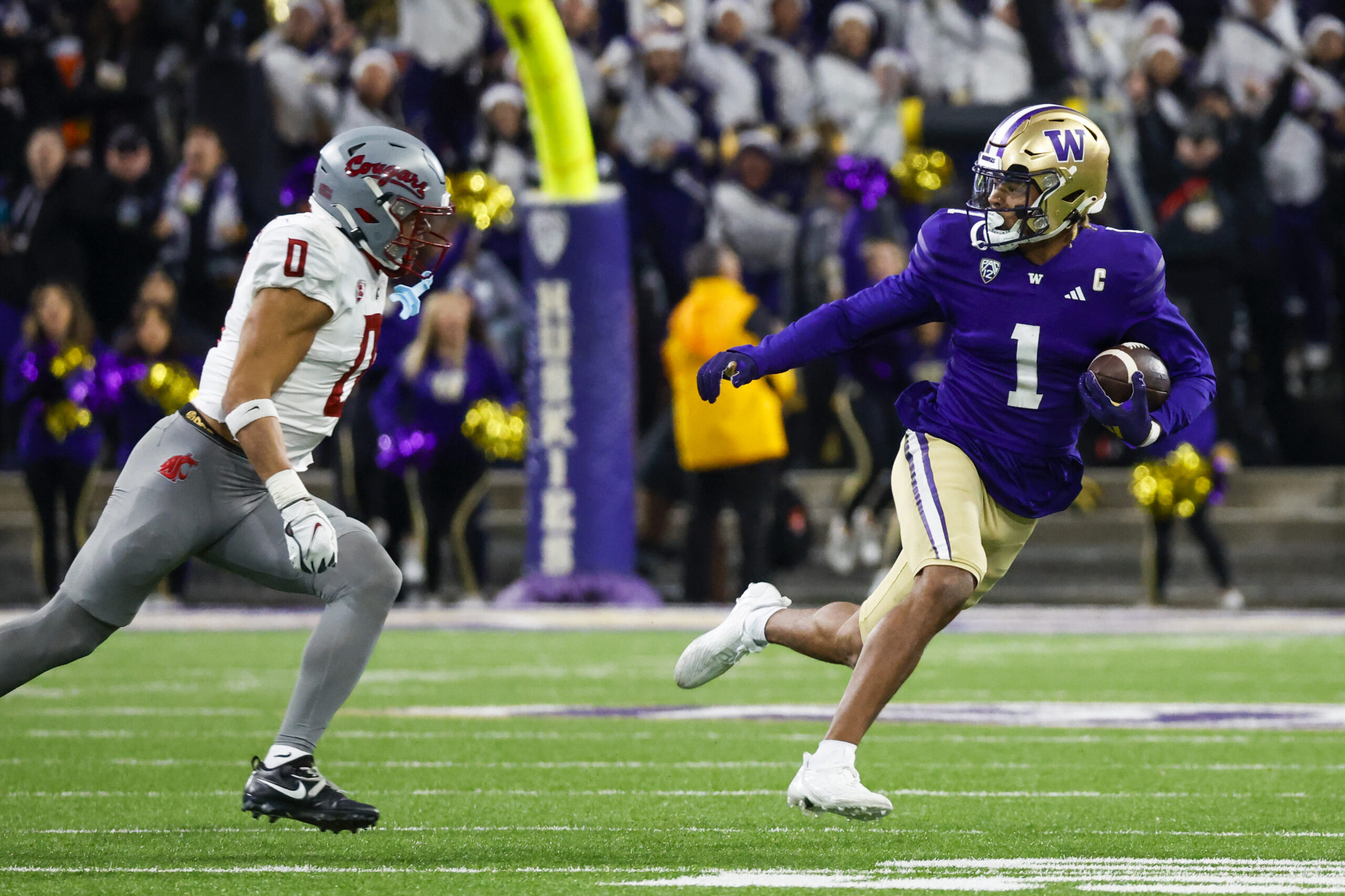Nov 25, 2023; Seattle, Washington, USA; Washington Huskies wide receiver Rome Odunze (1) rushes against Washington State Cougars defensive back Sam Lockett III (0) during the fourth quarter at Alaska Airlines Field at Husky Stadium.