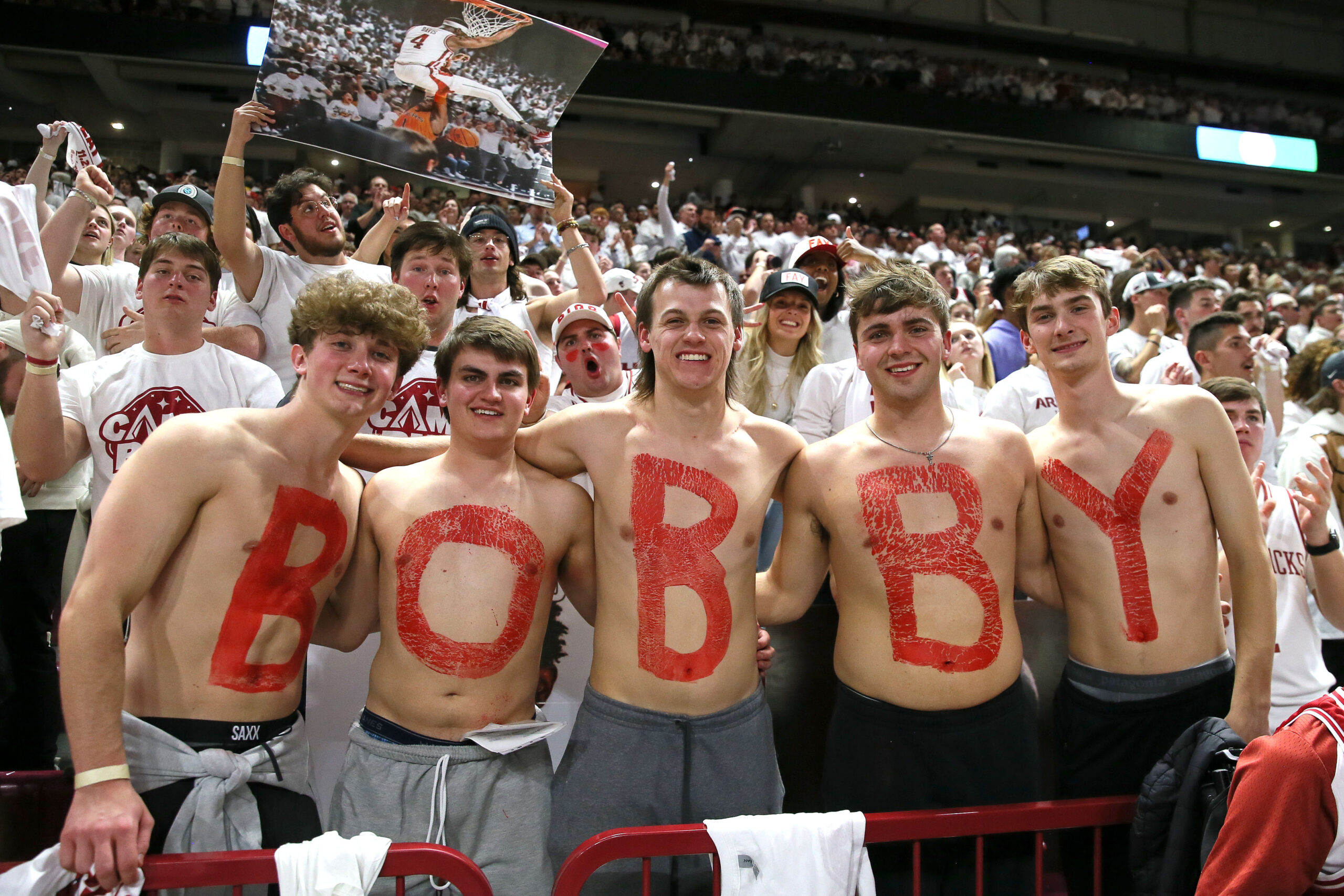 Nov 29, 2023; Fayetteville, Arkansas, USA; Arkansas Razorbacks students paint their chest for recently hired offensive coordinator Bobby Petrino during the game against the Duke Blue Devils at Bud Walton Arena. Arkansas won 80-75.
