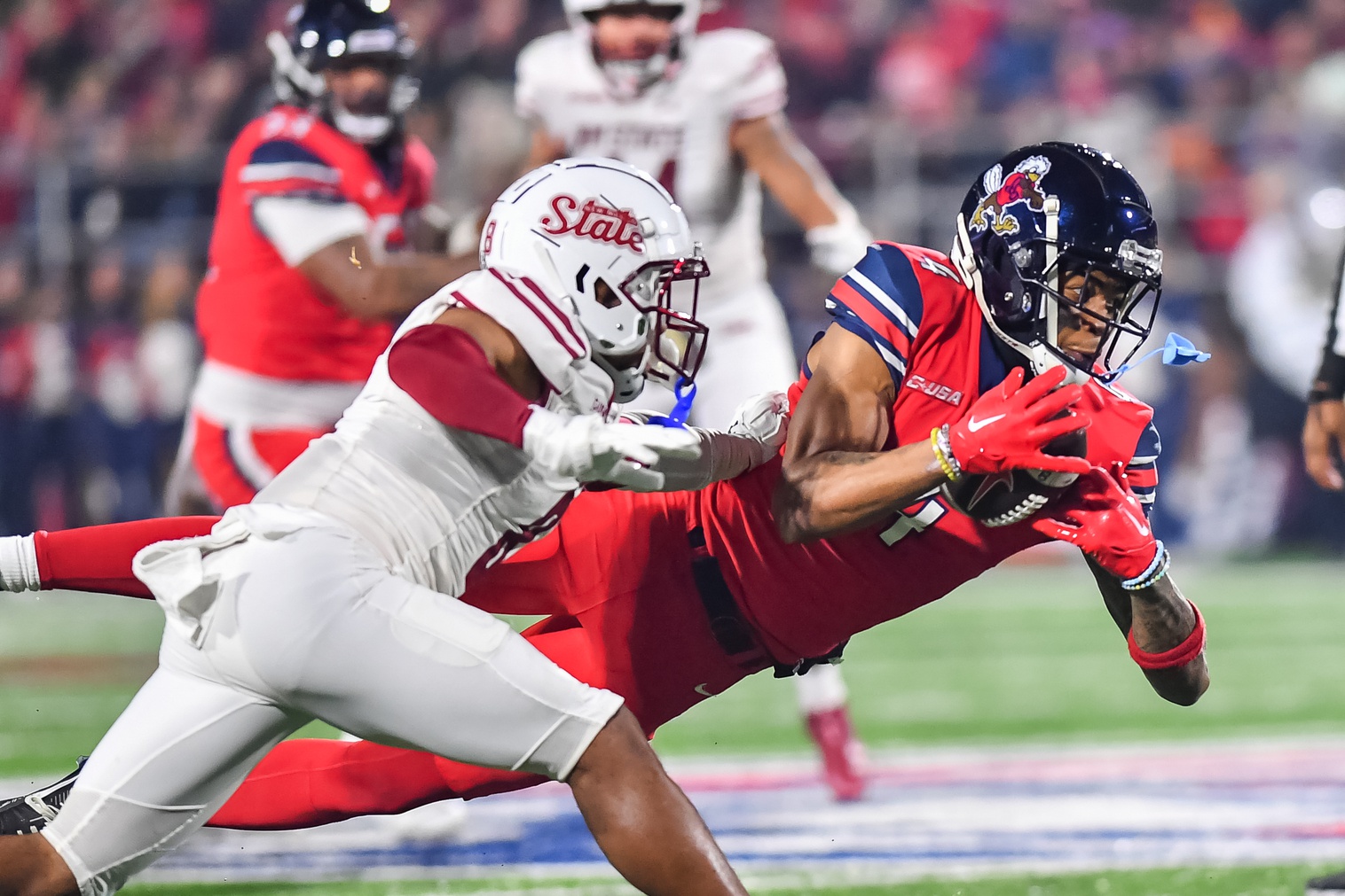 Dec 1, 2023; Lynchburg, VA, USA; Liberty Flames wide receiver CJ Daniels (4) catches a pass against the New Mexico State Aggies during the first quarter at Williams Stadium.