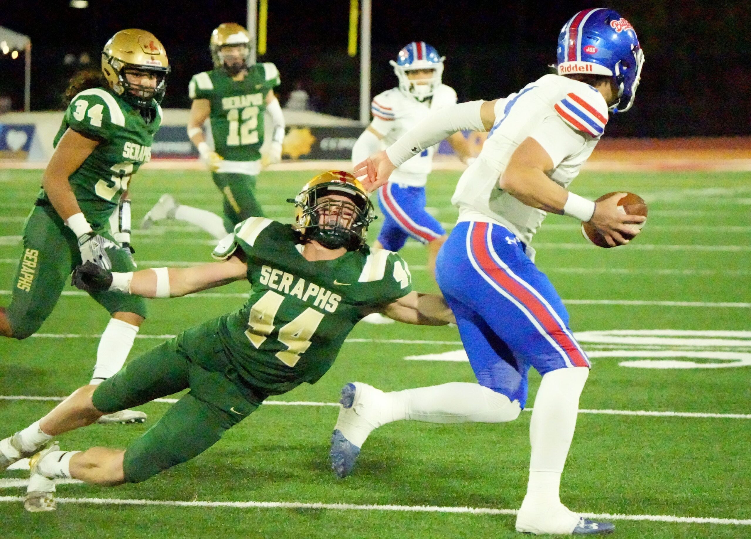St. Bonaventure High safety Dylan Dunst reaches for Folsom High quarterback Ryder Lyons during the CIF-State Division 1-A state championship bowl at Saddleback College in Mission Viejo on Saturday, Dec. 9, 2023. The Seraphs lost 20-14. © JUAN CARLO/THE STAR / USA TODAY NETWORK