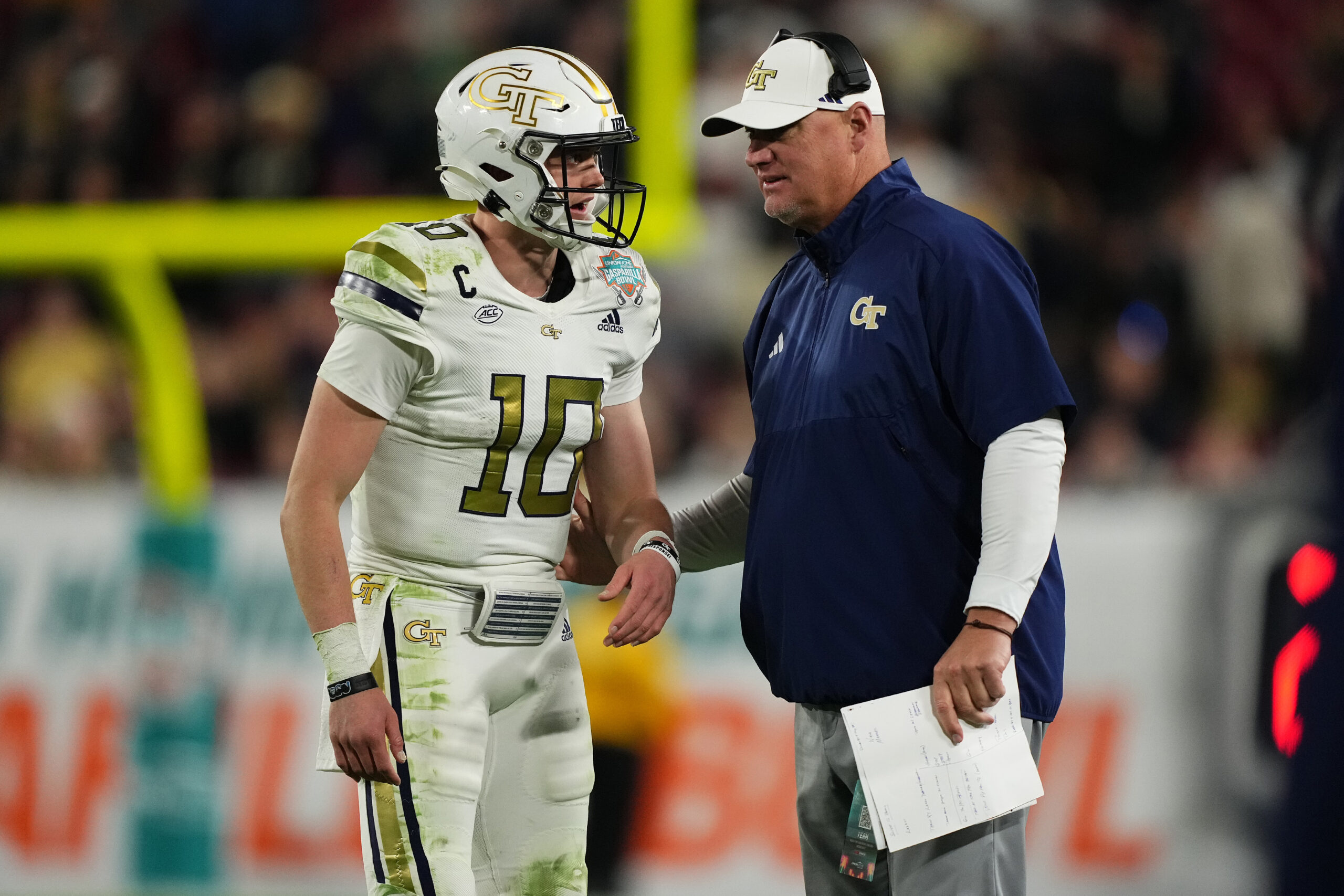 Dec 22, 2023; Tampa, FL, USA; Georgia Tech Yellow Jackets quarterback Haynes King (10) talks with head coach Brent Key during the second half of the Gasparilla Bowl against the UCF Knights at Raymond James Stadium.
