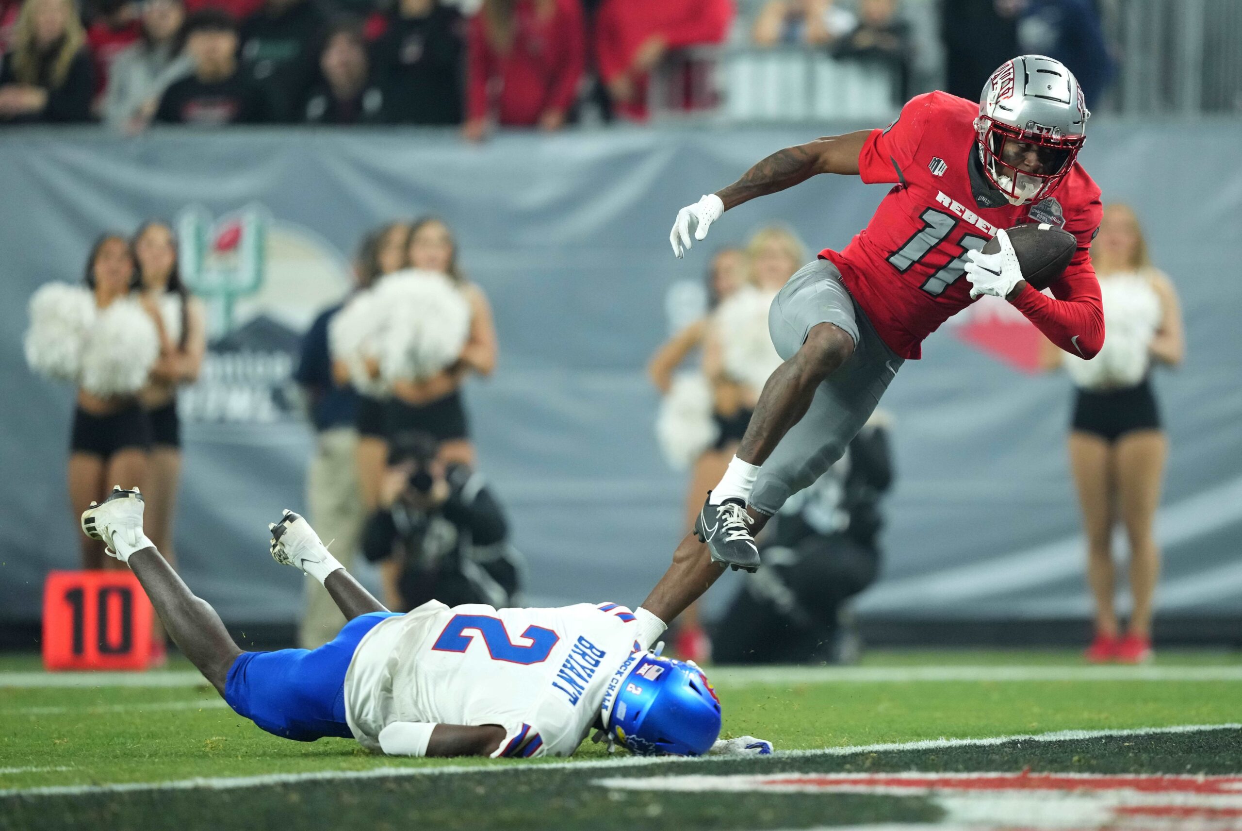 Dec 26, 2023; Phoenix, AZ, USA; UNLV Rebels wide receiver Ricky White (11) catches a touchdown pass against Kansas Jayhawks cornerback Cobee Bryant (2) during the second half at Chase Field