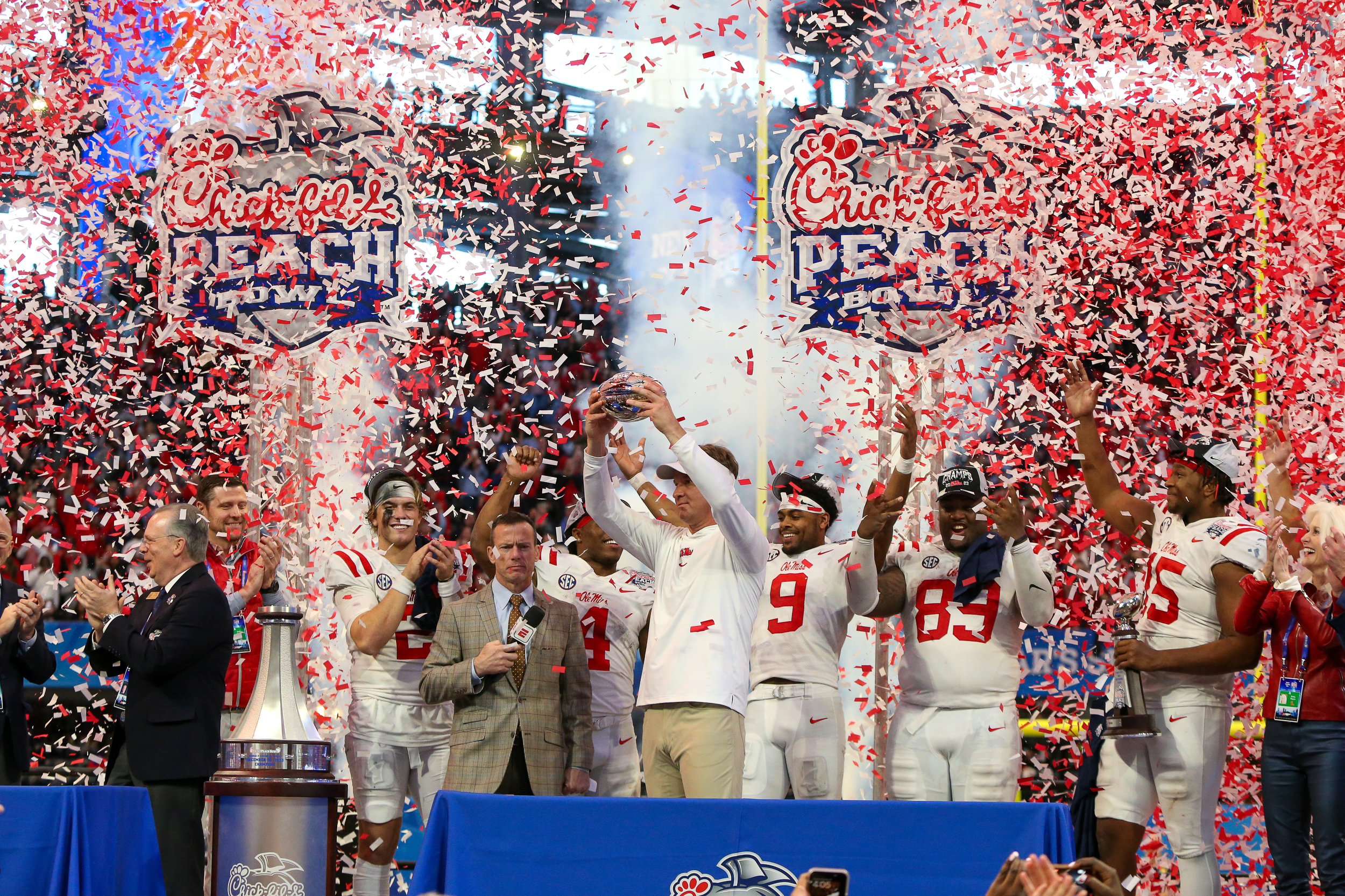 Dec 30, 2023; Atlanta, GA, USA; Mississippi Rebels head coach Lane Kiffin holds up the Peach Bowl trophy after a victory against the Penn State Nittany Lions at Mercedes-Benz Stadium.