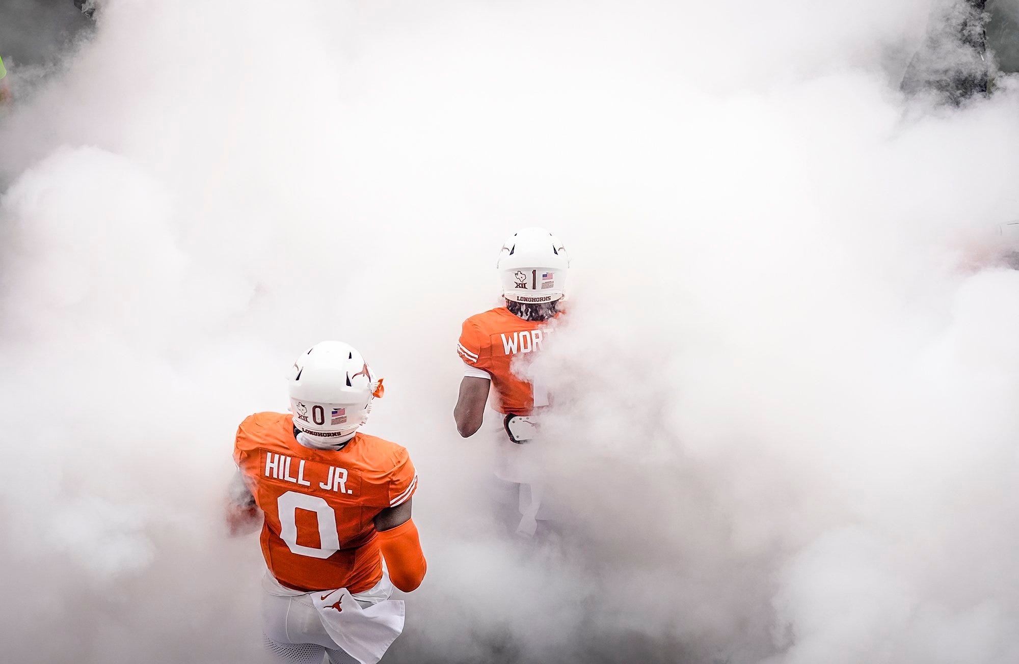 Texas Longhorns wide receiver Xavier Worthy (1) and Texas Longhorns linebacker Anthony Hill Jr. (0) make their way take the field against Kansas State Wildcats at the start of an NCAA college football game, Saturday, November. 4, 2023, in Austin, Texas.