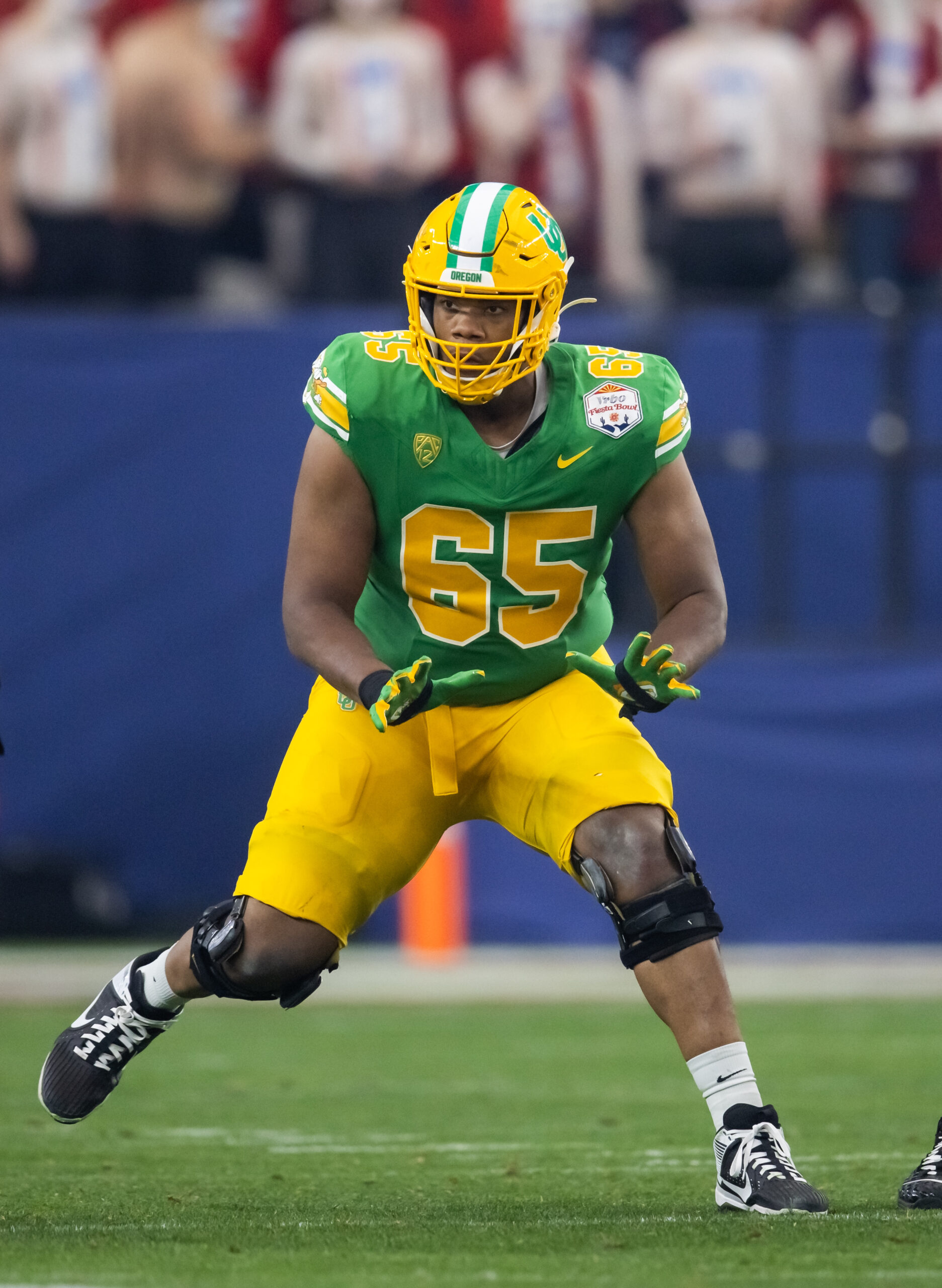 Jan 1, 2024; Glendale, AZ, USA; Oregon Ducks offensive lineman Ajani Cornelius (65) against the Liberty Flames during the 2024 Fiesta Bowl at State Farm Stadium.