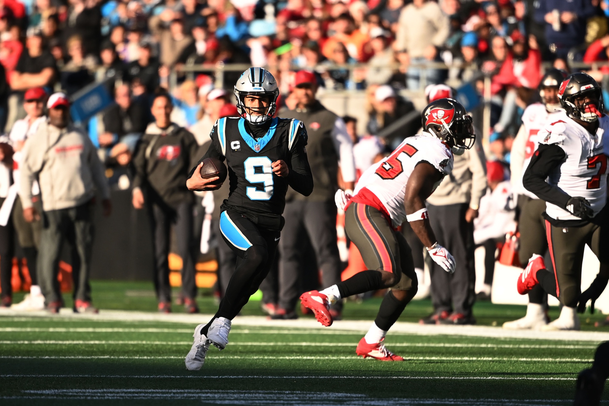 Jan 7, 2024; Charlotte, North Carolina, USA; Carolina Panthers quarterback Bryce Young (9) scrambles in the fourth quarter at Bank of America Stadium.