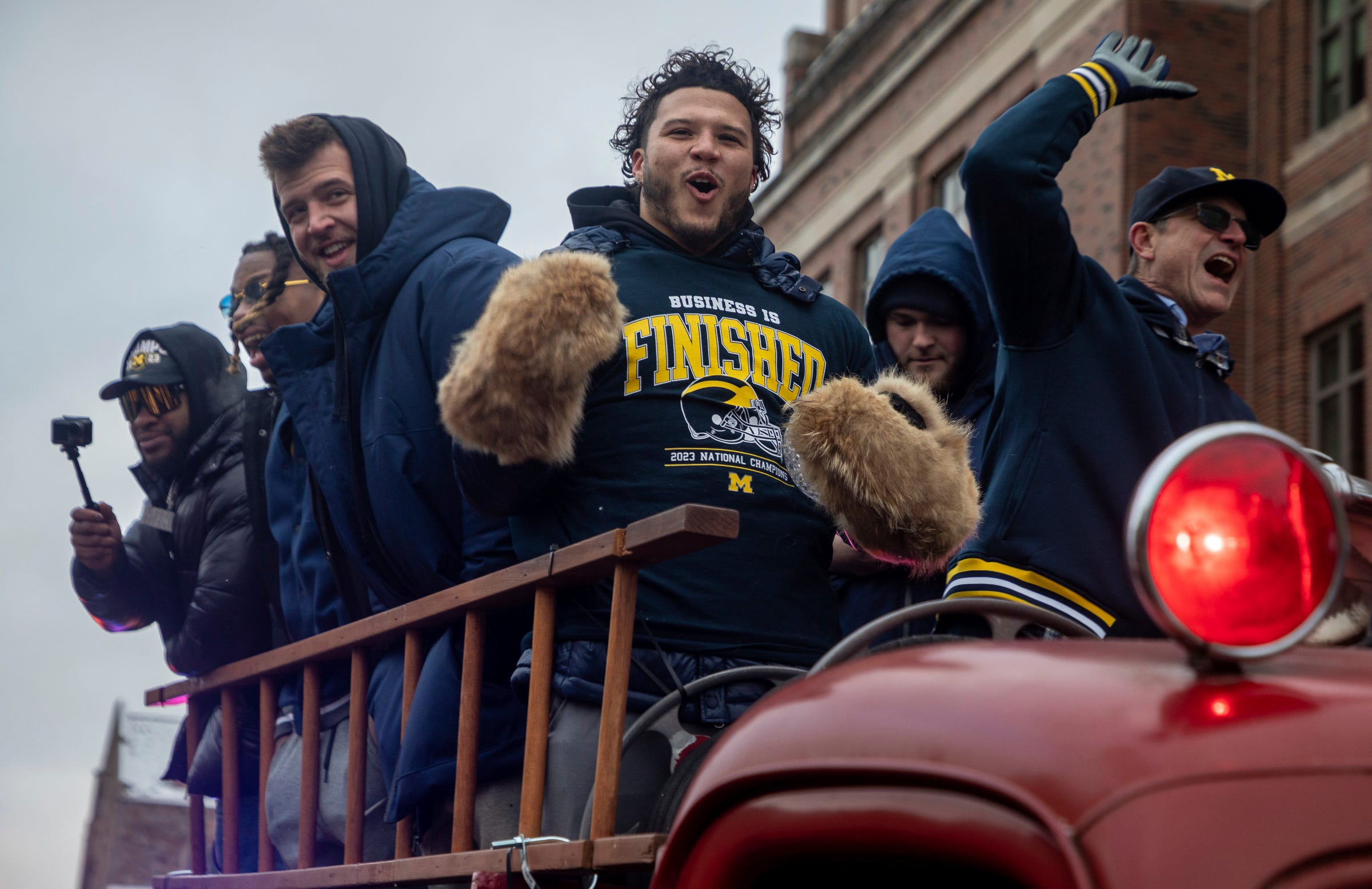 Jan 13, 2024; Ann Arbor, MI, USA; Michigan players Trevor Keegan, left, Blake Corum, middle, and head coach Jim Harbaugh celebrate with the fans during a parade at the University of Michigan campus in Ann Arbor on Saturday, Jan. 13, 2024. The Wolverines were crowned 2023 National Champions.