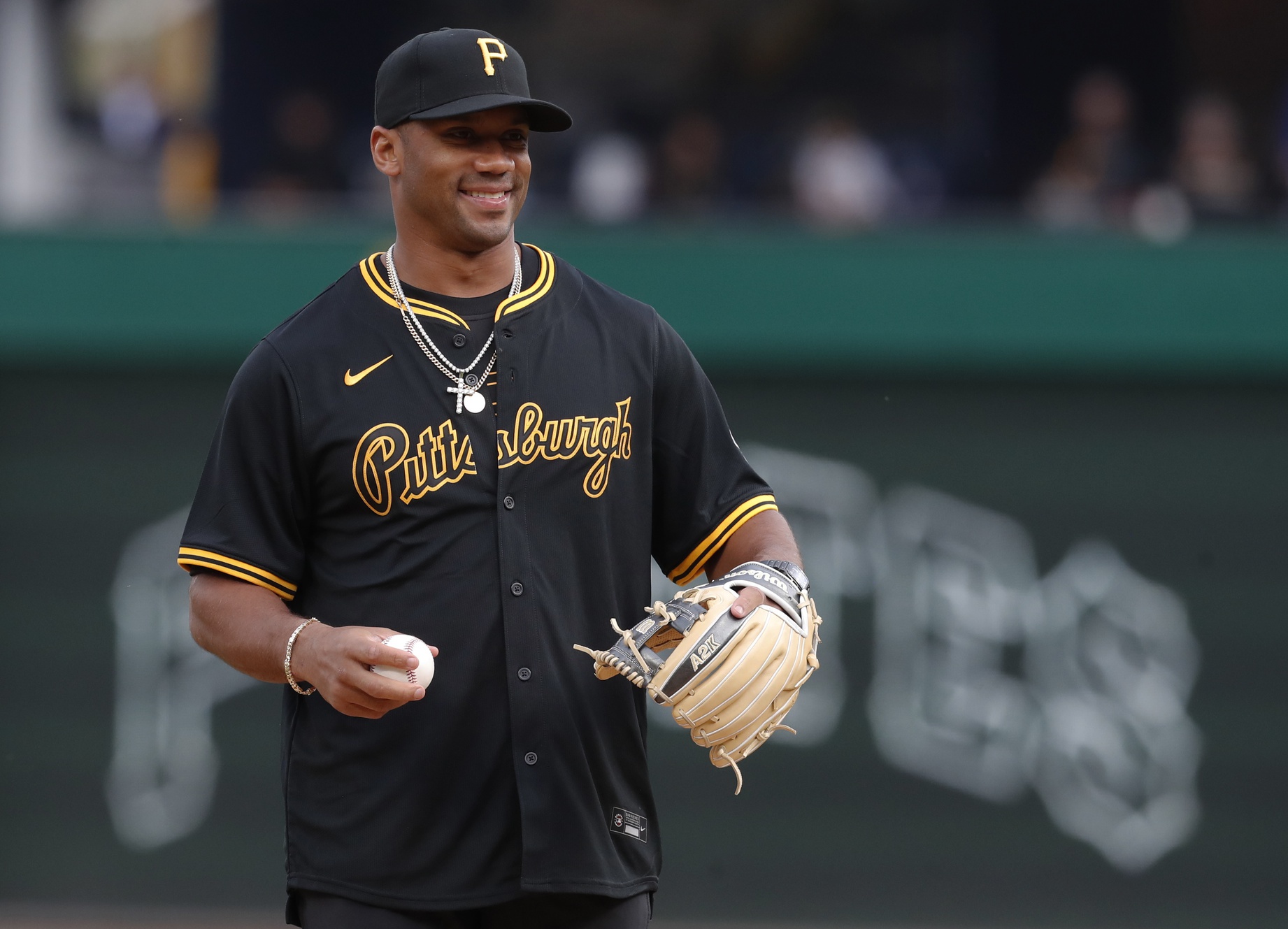 Apr 19, 2024; Pittsburgh, Pennsylvania, USA; Pittsburgh Steelers quarterback Russell Wilson (3) throws out a ceremonial first pitch before the Pittsburgh Pirates host the Boston Red Sox at PNC Park.