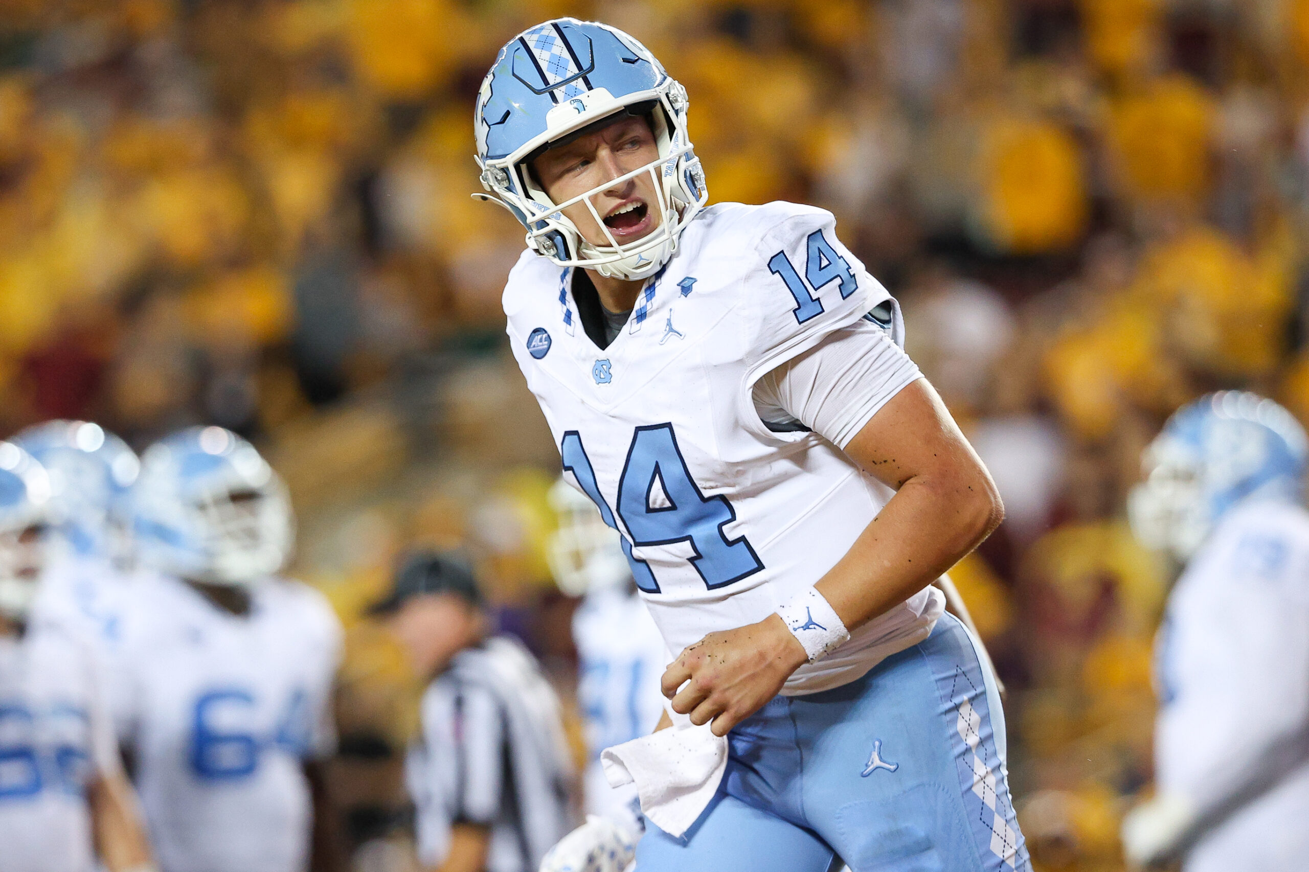 Aug 29, 2024; Minneapolis, Minnesota, USA; North Carolina Tar Heels quarterback Max Johnson (14) celebrates his rushing touchdown against the Minnesota Golden Gophers during the first half at Huntington Bank Stadium. Mandatory Credit: Matt Krohn-Imagn Images