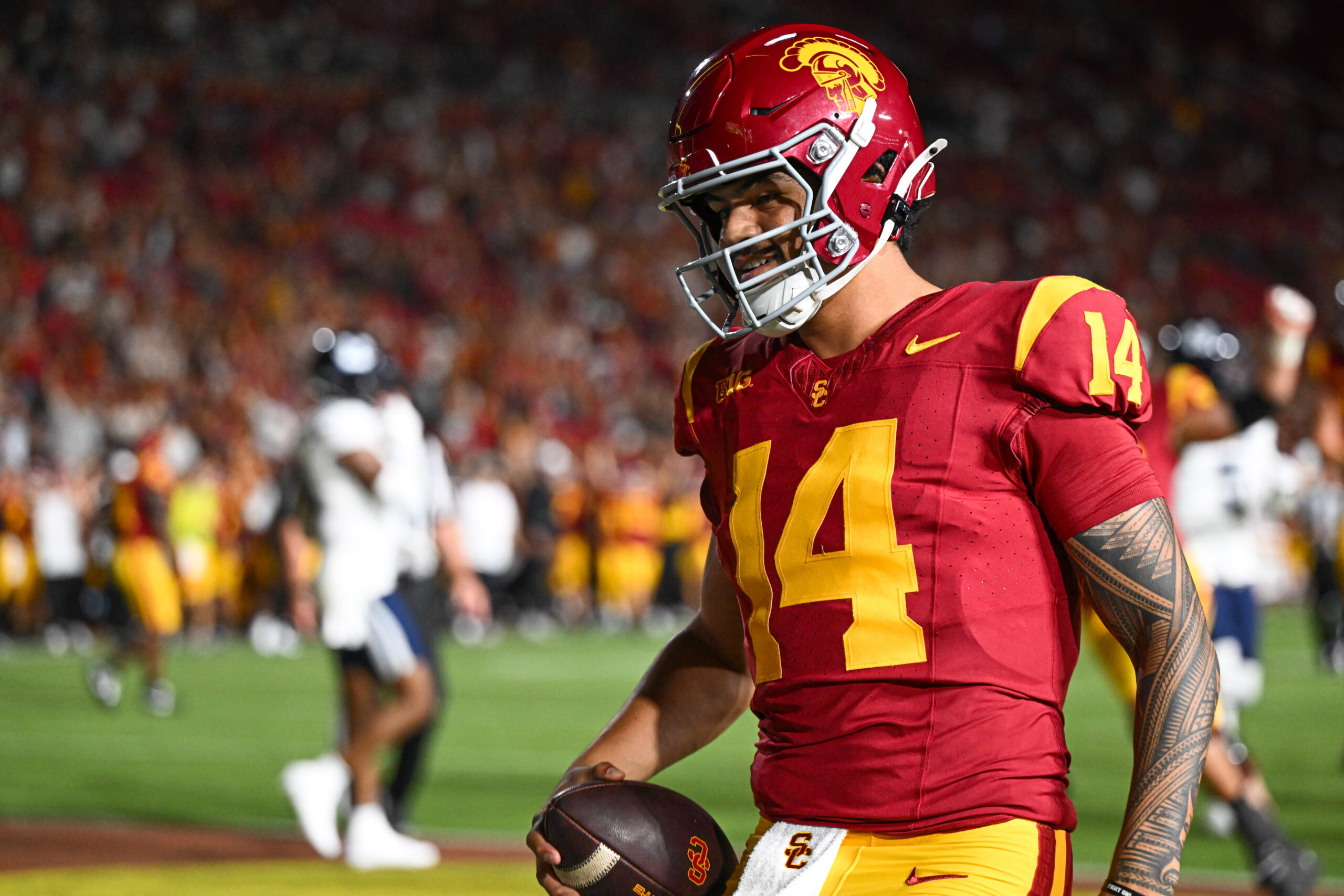 Sep 7, 2024; Los Angeles, California, USA; USC Trojans quarterback Jayden Maiava (14) scores a touchdown against the Utah State Aggies during the fourth quarter at United Airlines Field at Los Angeles Memorial Coliseum.