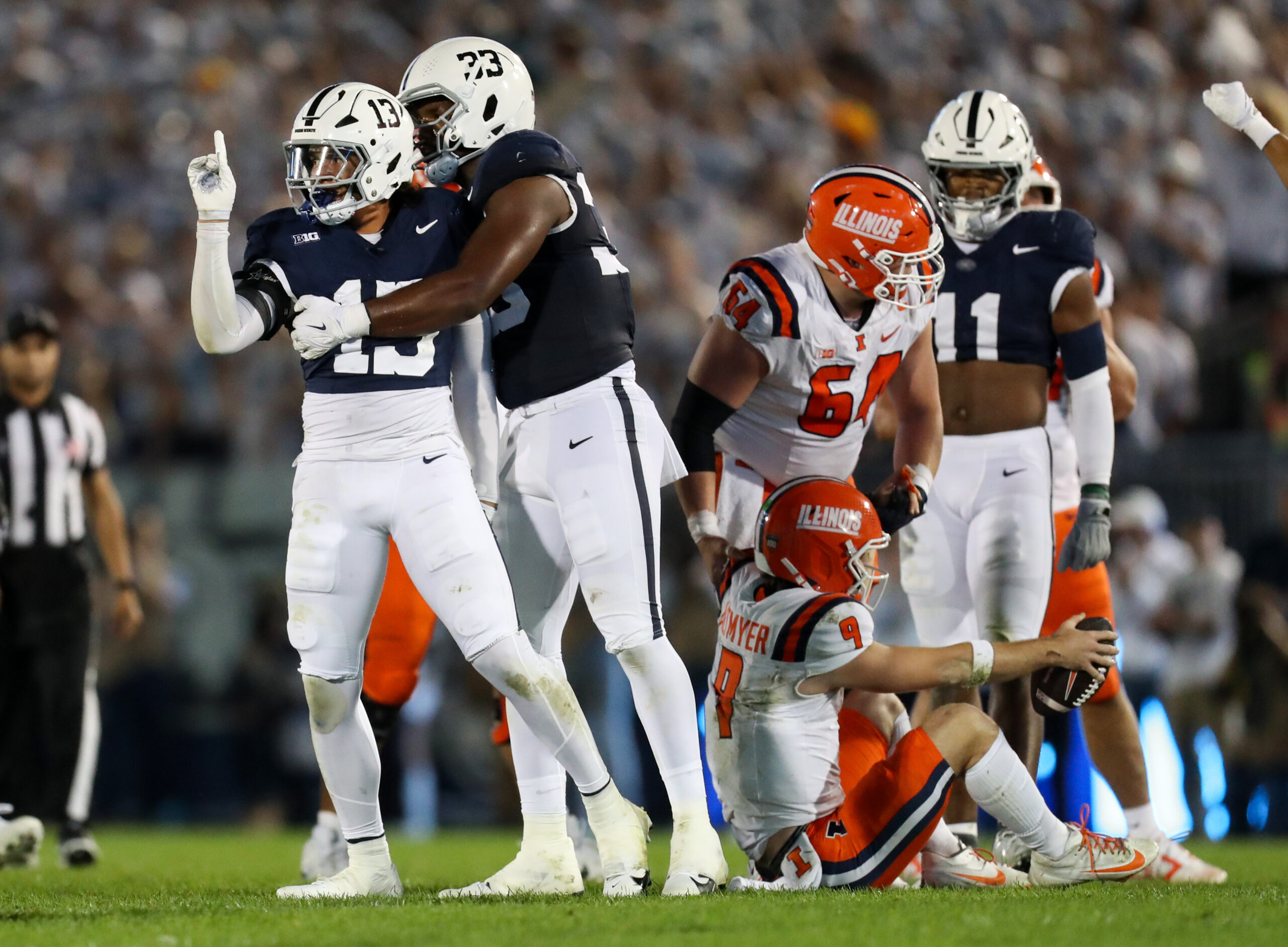 Penn State Nittany Lions linebacker Tony Rojas (13) reacts after tackling Illinois Fighting Illini quarterback Luke Altmyer (9) on third down during the first quarter at Beaver Stadium.