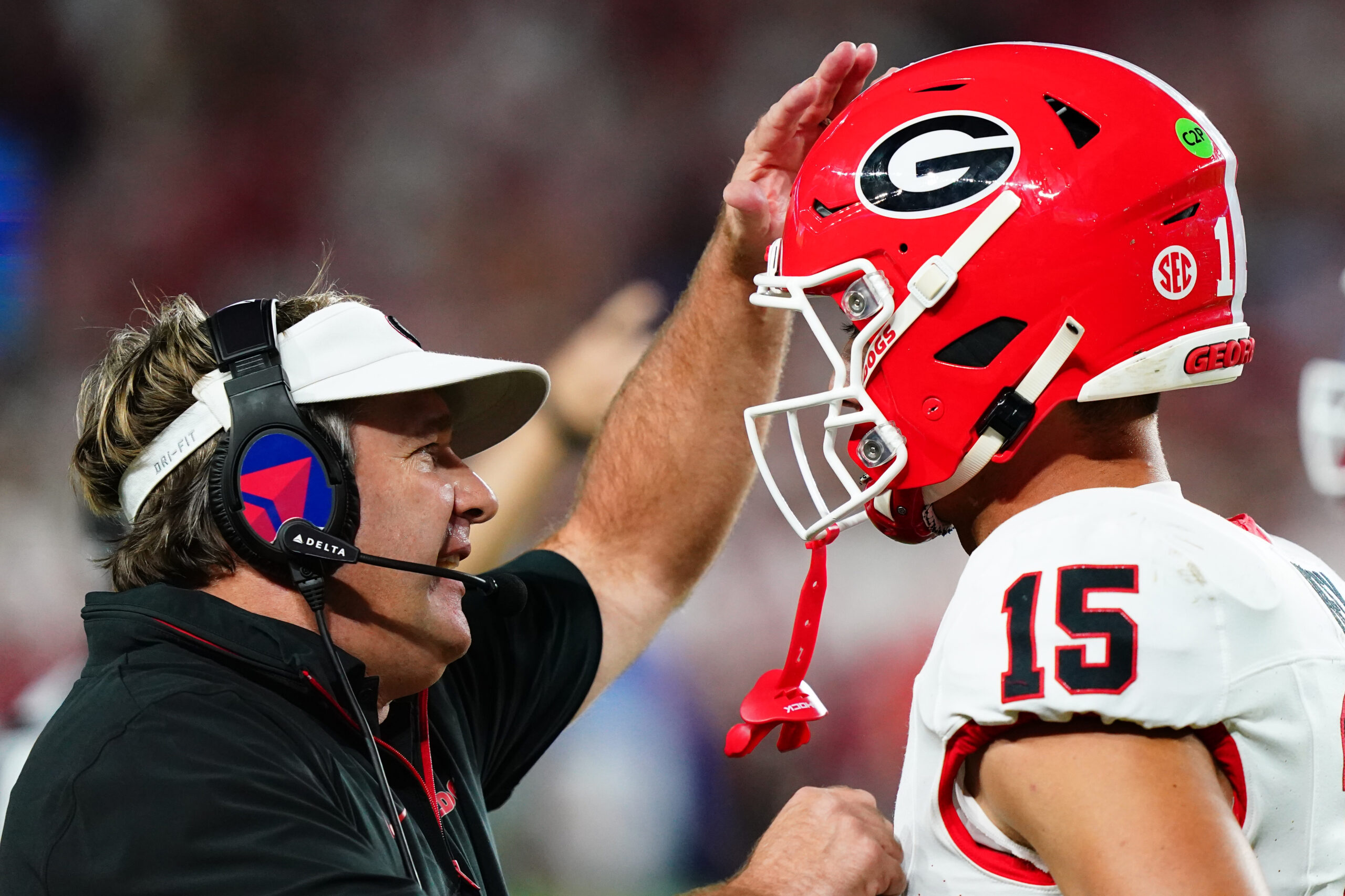 Georgia Bulldogs head coach Kirby Smart talks with quarterback Carson Beck (15) during the first half against the Alabama Crimson Tide at Bryant-Denny Stadium.