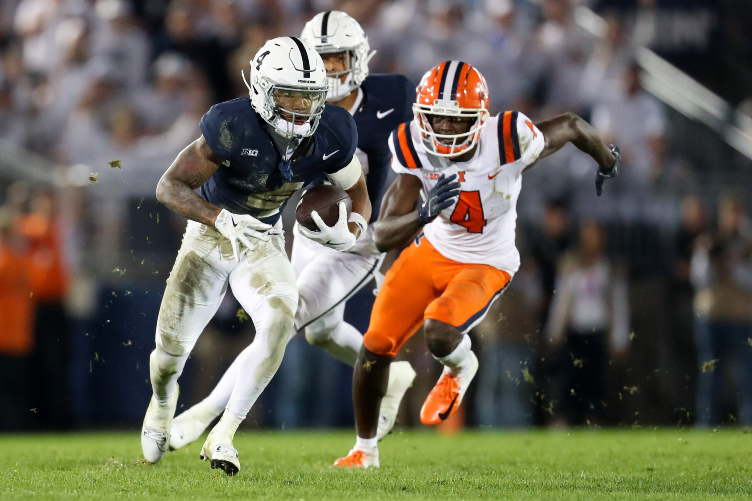 Sep 28, 2024; University Park, Pennsylvania, USA; Penn State Nittany Lions cornerback AJ Harris (4) runs after an interception during the fourth quarter against the Illinois Fighting Illini at Beaver Stadium. Penn State defeated Illinois 21-7.