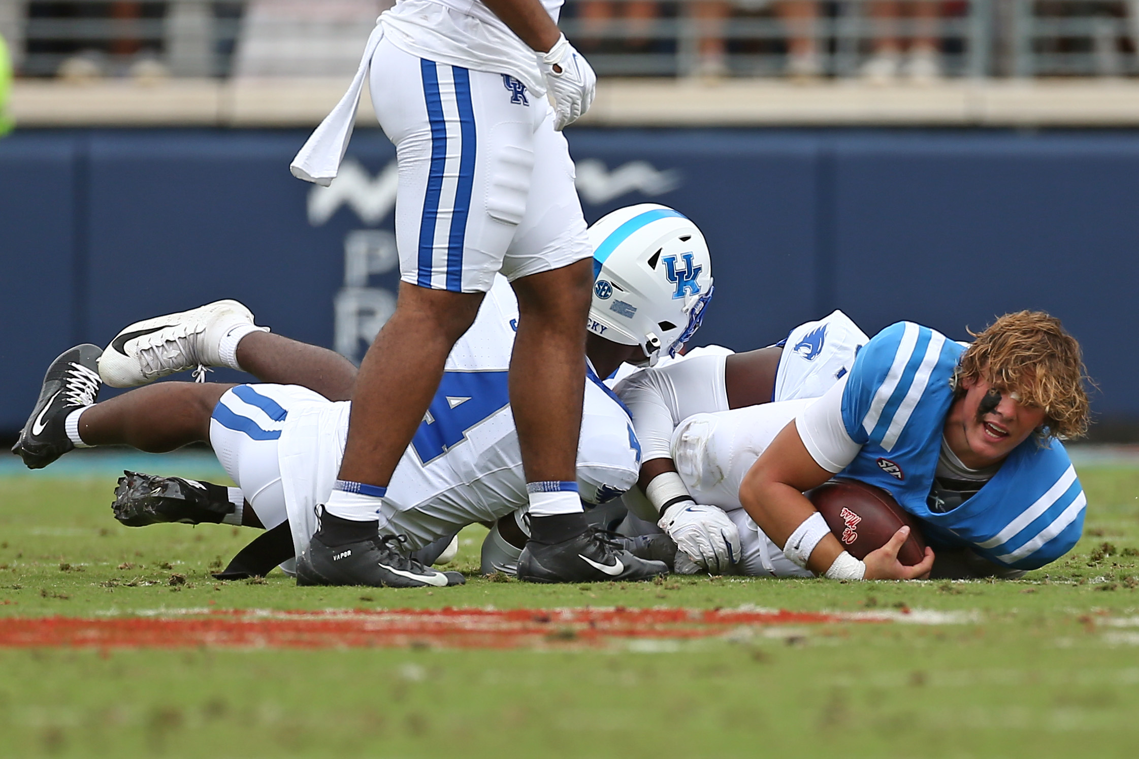 Sep 28, 2024; Oxford, Mississippi, USA; Mississippi Rebels quarterback Jaxson Dart (2) lays on the ground after being tackled by Kentucky Wildcats defensive back Kristian Story (4) during the first half at Vaught-Hemingway Stadium.