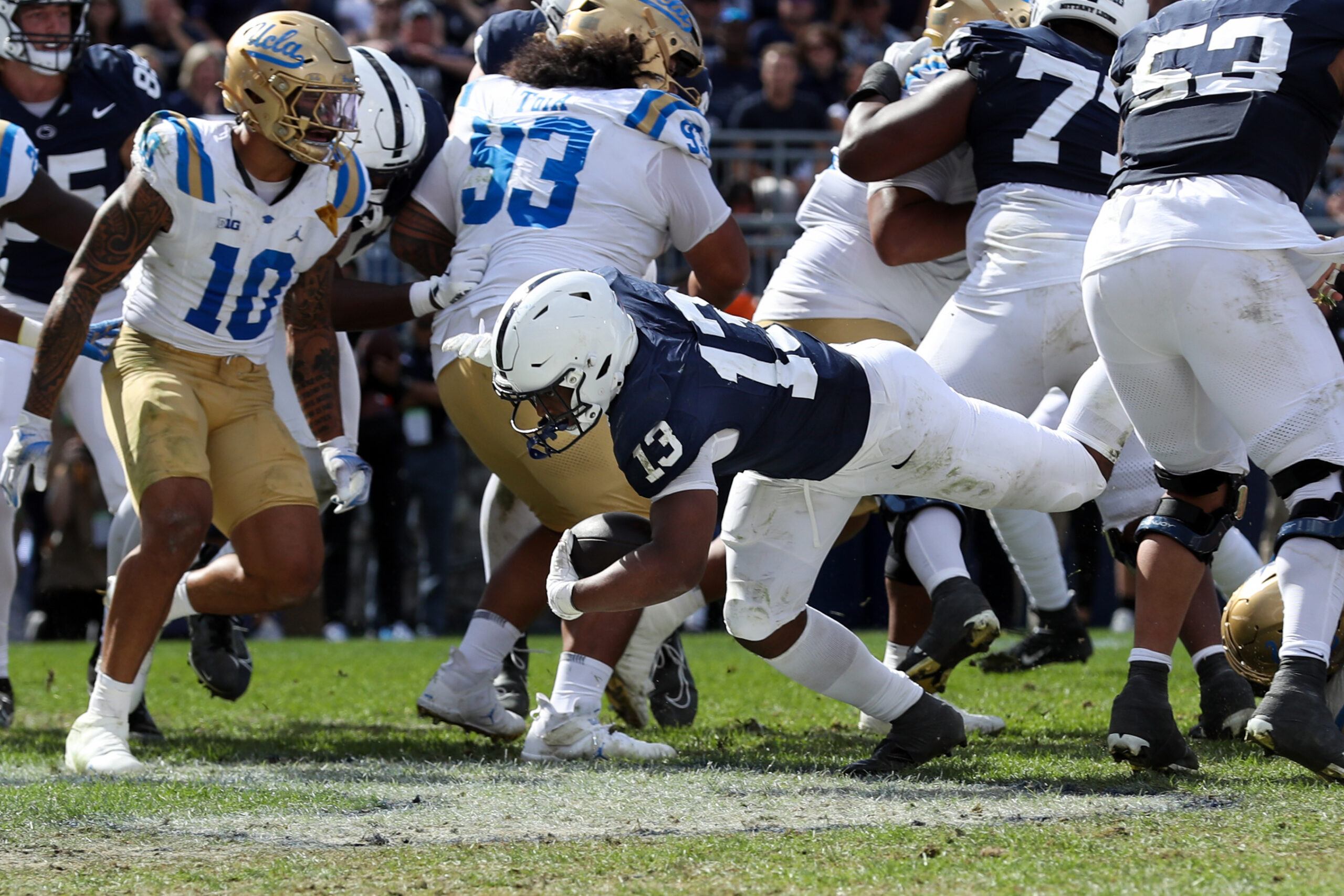 Oct 5, 2024; University Park, Pennsylvania, USA; Penn State Nittany Lions running back Kaytron Allen (13) runs with the ball into the end zone for a touchdown during the third quarter against the UCLA Bruins at Beaver Stadium.
