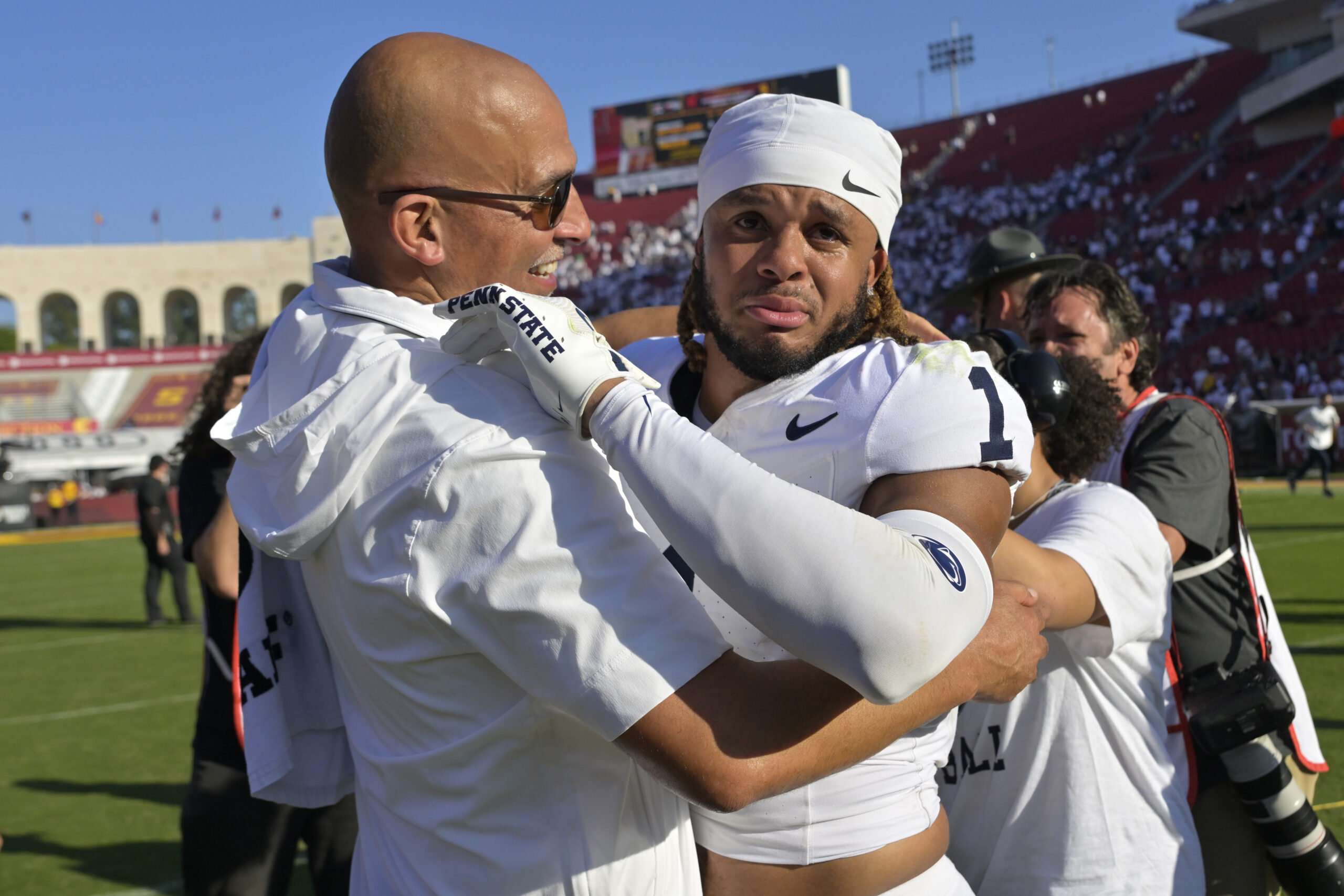 Oct 12, 2024; Los Angeles, California, USA; Penn State Nittany Lions safety Jaylen Reed (1) is congratulated by head coach James Franklin after defeating the USC Trojans in overtime at United Airlines Field at the Los Angeles Memorial Coliseum.