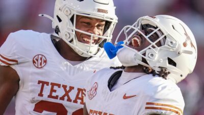 Texas Longhorns wide receiver Silas Bolden (11) and Texas Longhorns defensive back Xavier Filsaime (21) celebrates a touchdown in the third quarter during the Red River Rivalry Football Game between the University of Oklahoma Sooners and the University of Texas Longhorns at the Cotton Bowl Stadium in Dallas