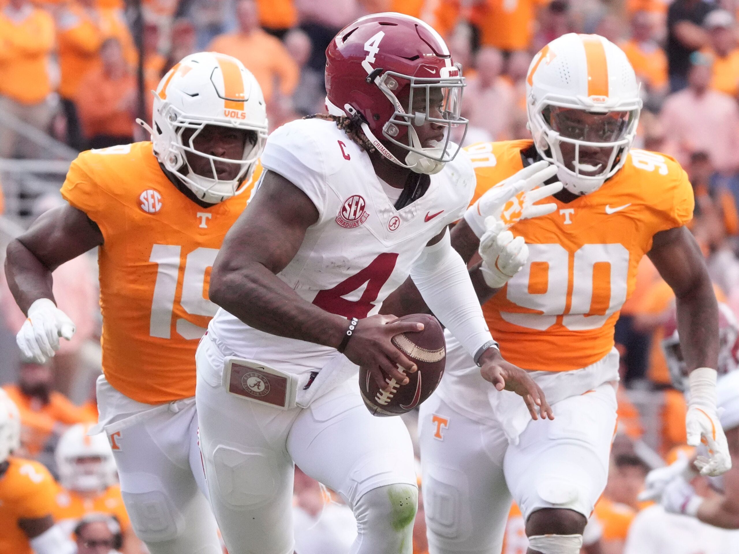 Alabama quarterback Jalen Milroe (4) is pressured by Tennessee defensive linemen Joshua Josephs (19) and Dominic Bailey (90) during an NCAA college football game on Saturday, Oct. 19, 2024, in Knoxville. Tenn.