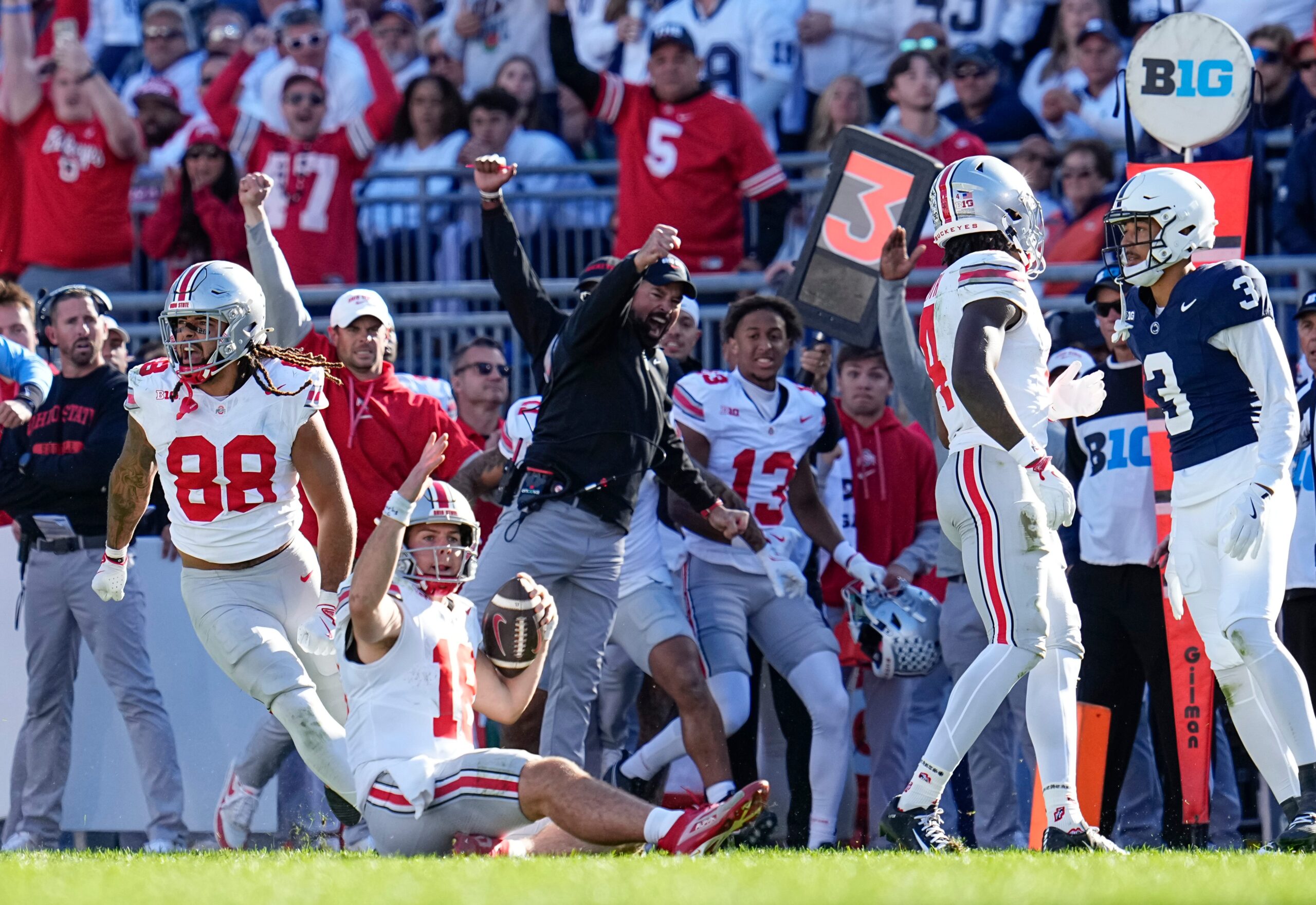 Ohio State Buckeyes quarterback Will Howard (18) and head coach Ryan Day react as Howard slides for a first down late in the second half of the NCAA football game at Beaver Stadium in University Park, Pa. on Saturday, Nov. 2, 2024. Ohio State won 20-13.