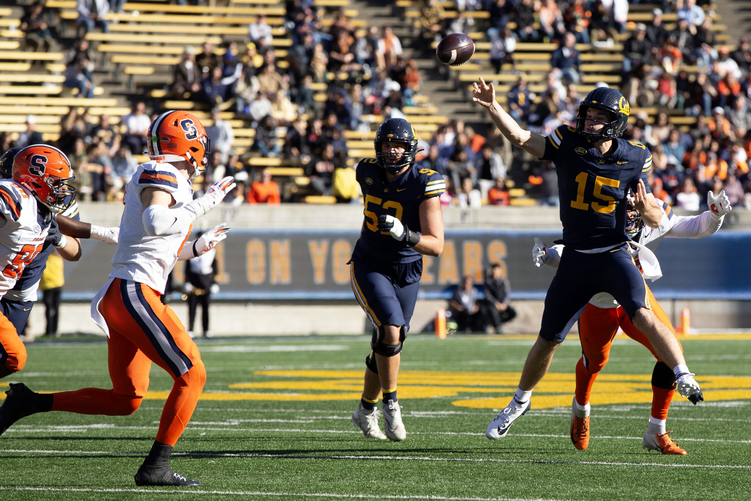 Nov 16, 2024; Berkeley, California, USA; California Golden Bears quarterback Fernando Mendoza (15) passes over two Syracuse Orange defenders during the second quarter at California Memorial Stadium.