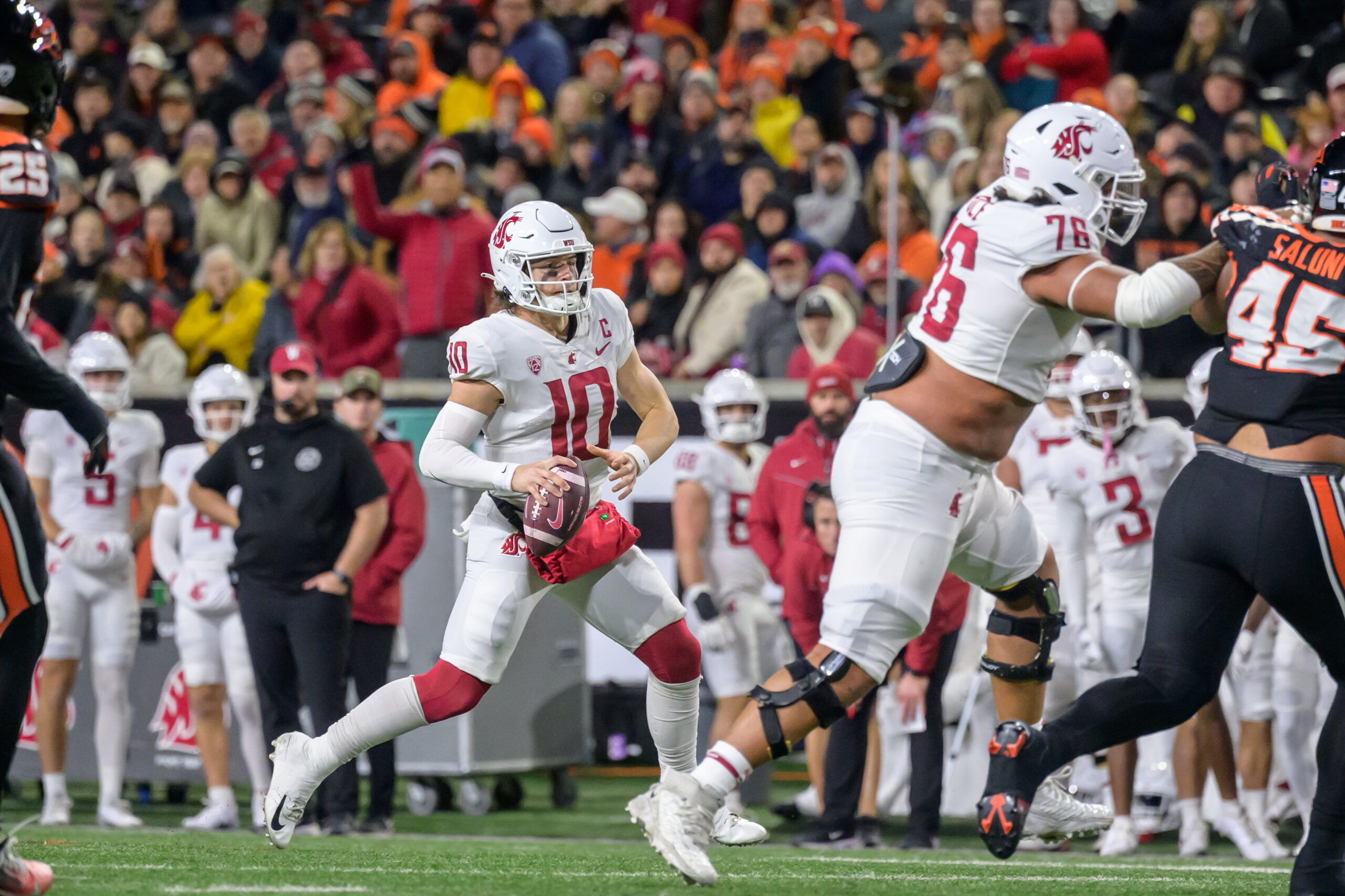 Nov 23, 2024; Corvallis, Oregon, USA; Washington State Cougars quarterback John Mateer (10) rolls out to pass during the second quarter against the Oregon State Beavers at Reser Stadium.