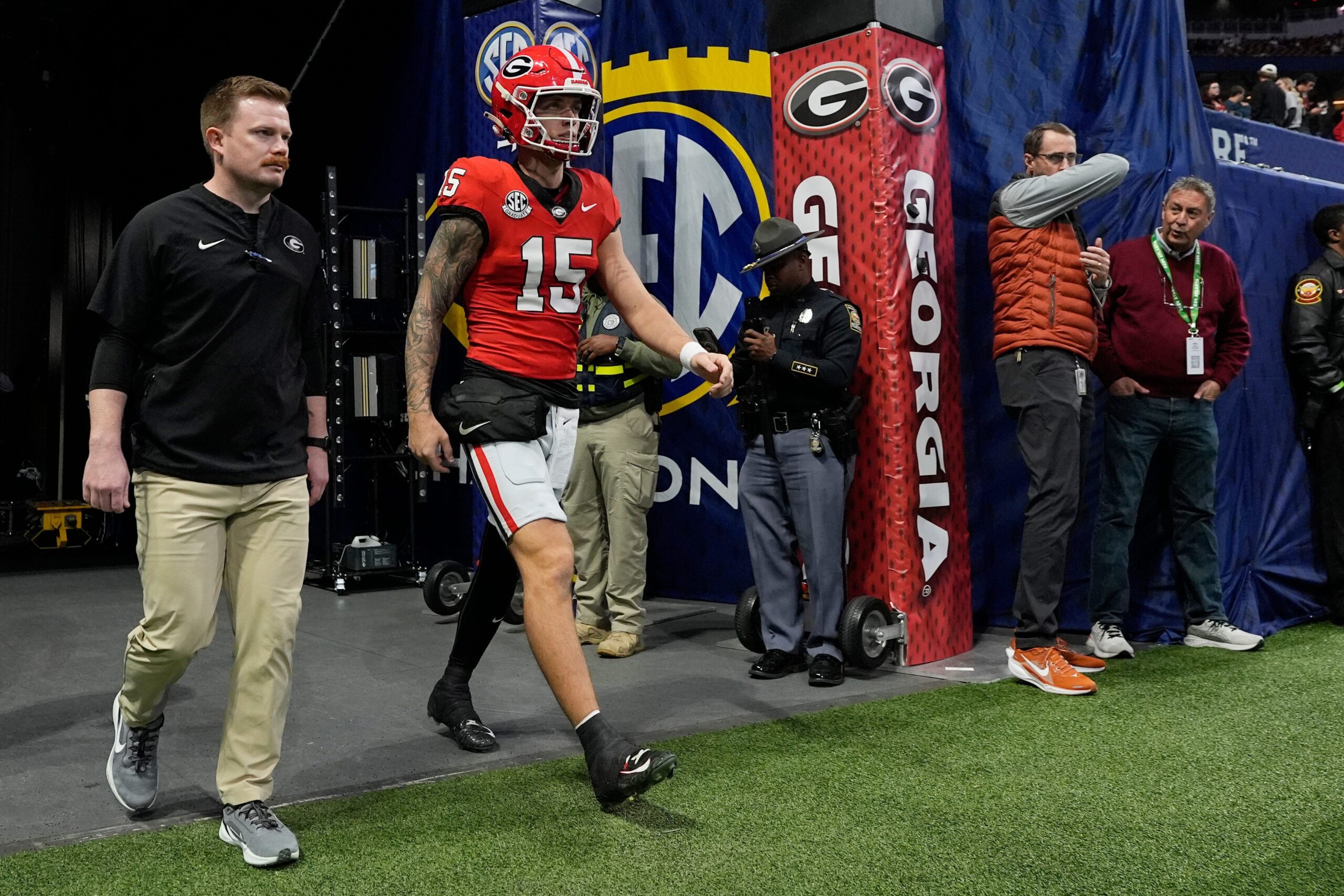 Georgia quarterback Carson Beck (15) takes the field to warm up before the start of the SEC championship game against Texas in Atlanta, on Saturday, Dec. 7, 2024.