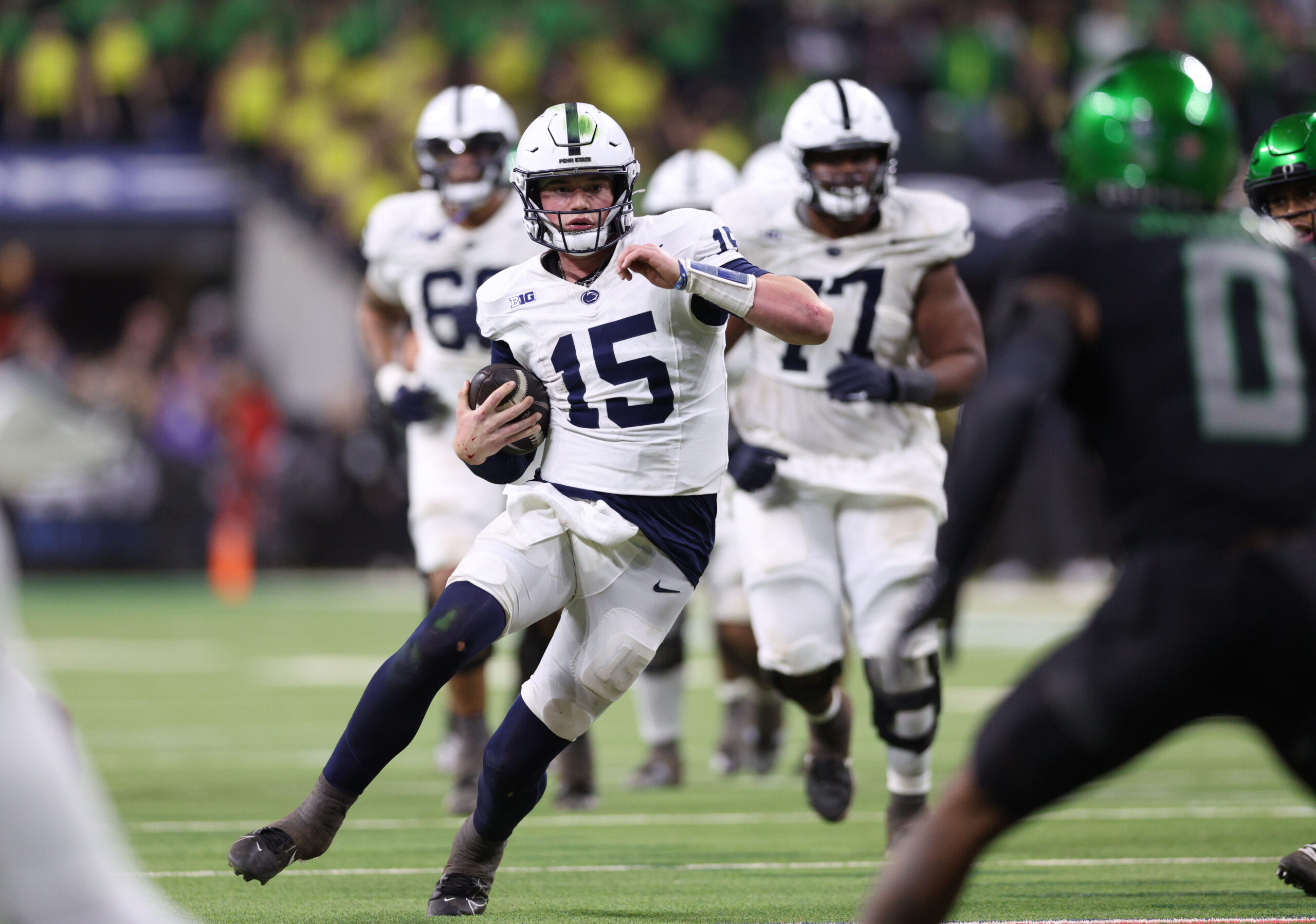 Dec 7, 2024; Indianapolis, IN, USA; Penn State Nittany Lions quarterback Drew Allar (15) runs for a gain against the Oregon Ducks during the fourth quarter in the 2024 Big Ten Championship game at Lucas Oil Stadium.