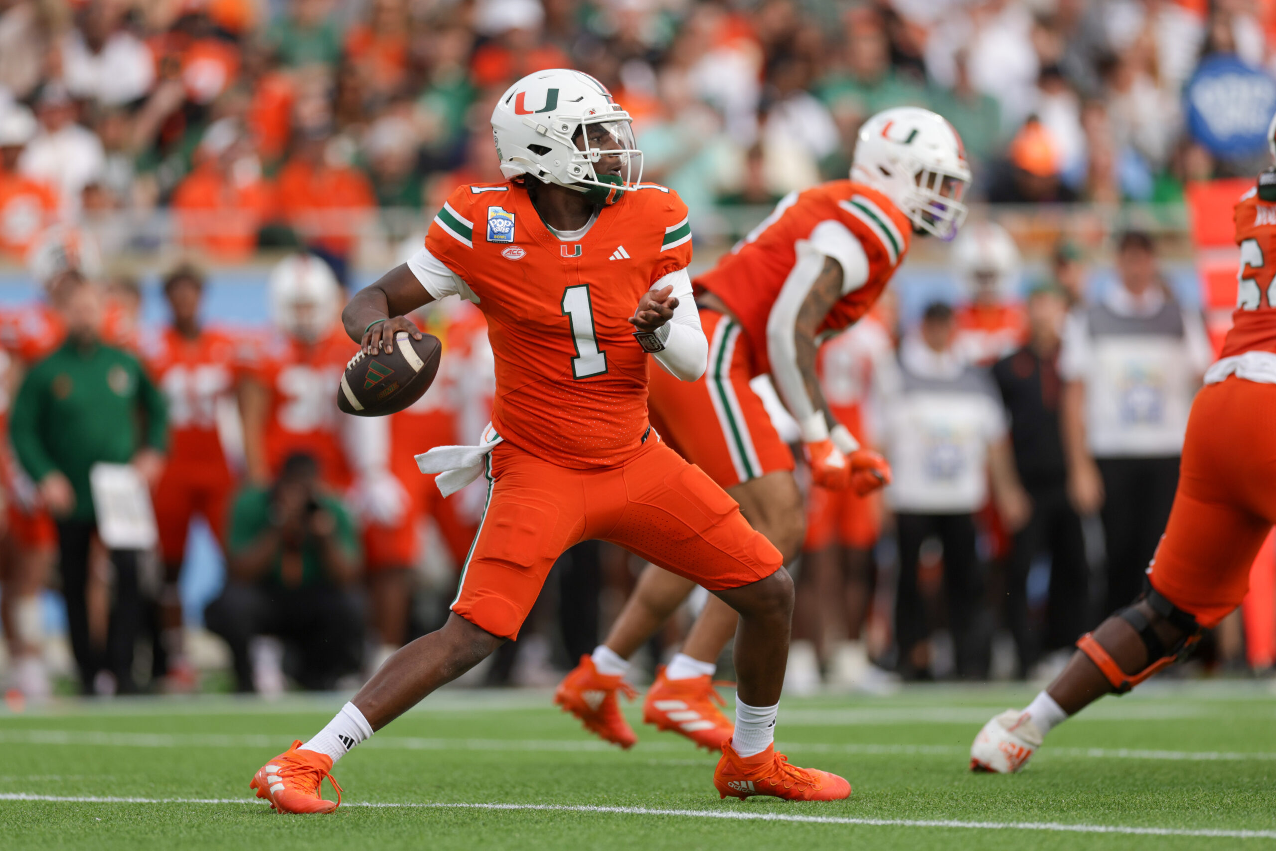 Dec 28, 2024; Orlando, FL, USA; Miami Hurricanes quarterback Cam Ward (1) drops back to pass against the Iowa State Cyclones in the first quarter during the Pop Tarts bowl at Camping World Stadium.