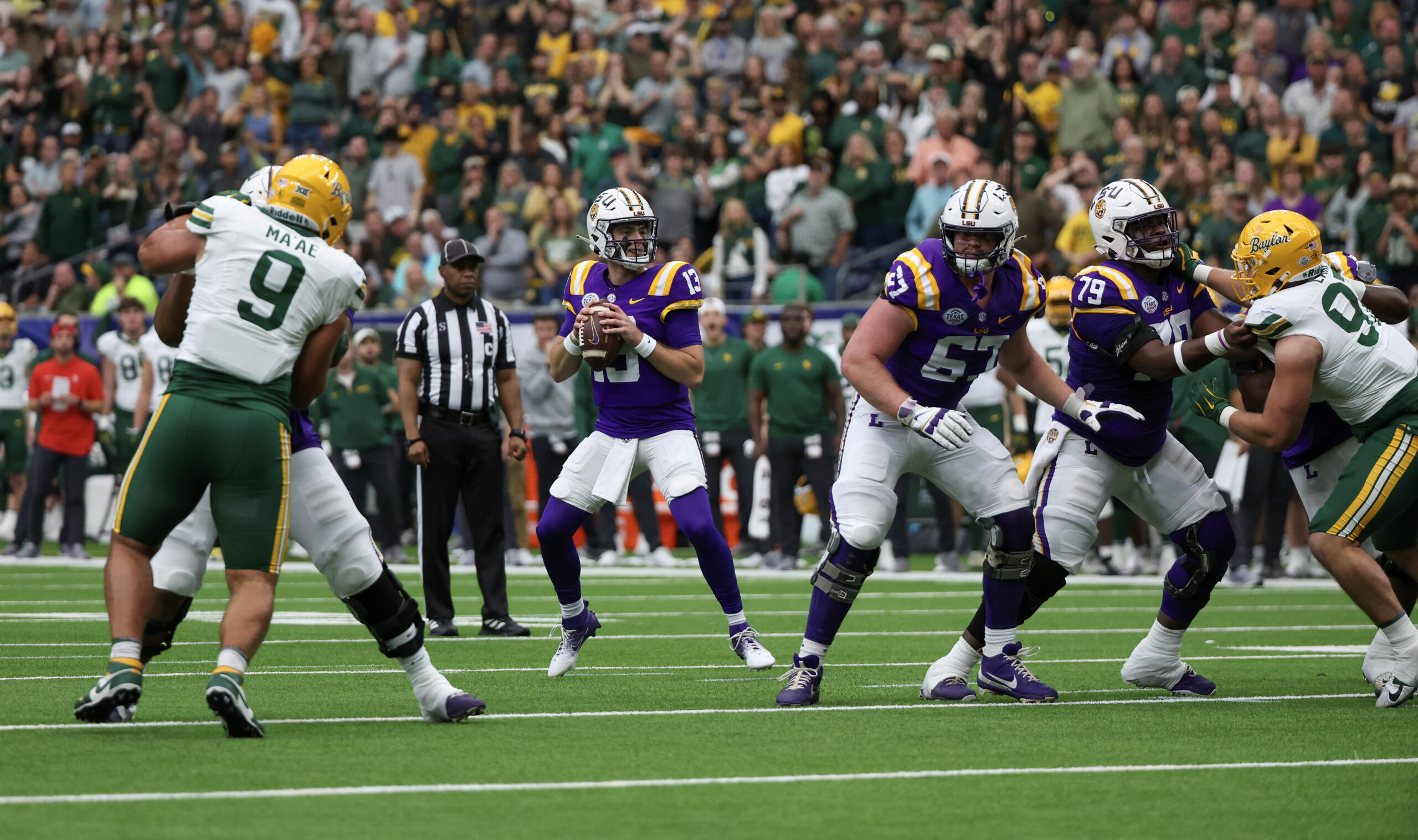 Dec 31, 2024; Houston, TX, USA; LSU Tigers quarterback Garrett Nussmeier (13) drops back to pass against the Baylor Bears in the first quarter at NRG Stadium.