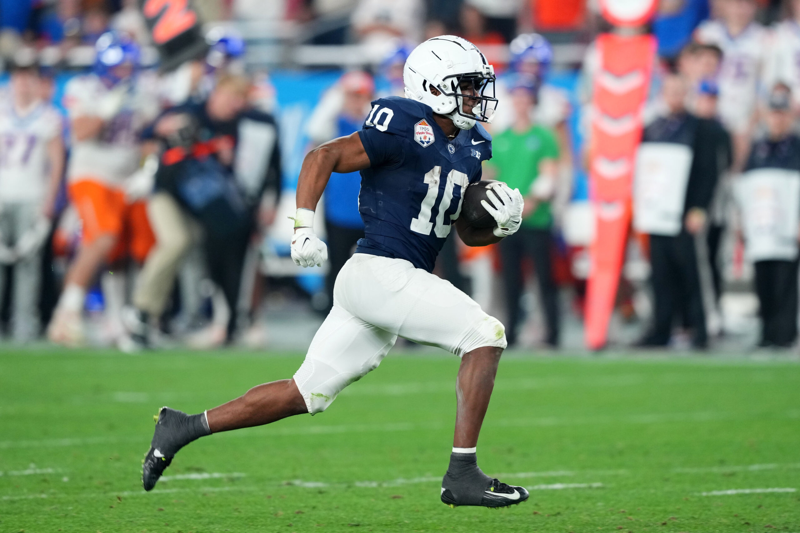 Dec 31, 2024; Glendale, AZ, USA; Penn State Nittany Lions running back Nicholas Singleton (10) rushes for a touchdown against the Boise State Broncos during the second half in the Fiesta Bowl at State Farm Stadium.