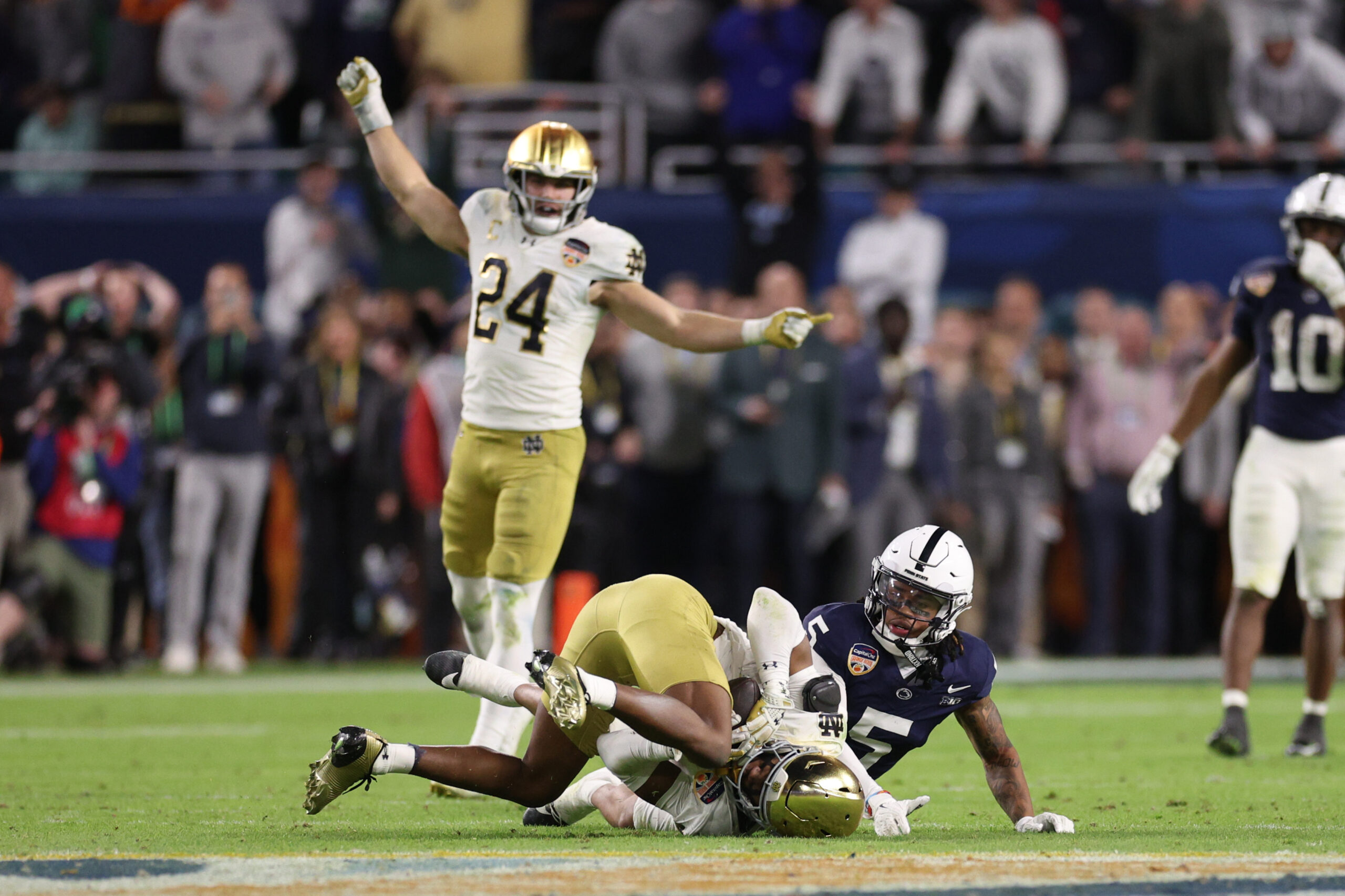 Jan 9, 2025; Miami, FL, USA; Notre Dame Fighting Irish cornerback Christian Gray (29) intercepts the ball in front of Penn State Nittany Lions wide receiver Omari Evans (5) in the second half in the Orange Bowl at Hard Rock Stadium.
