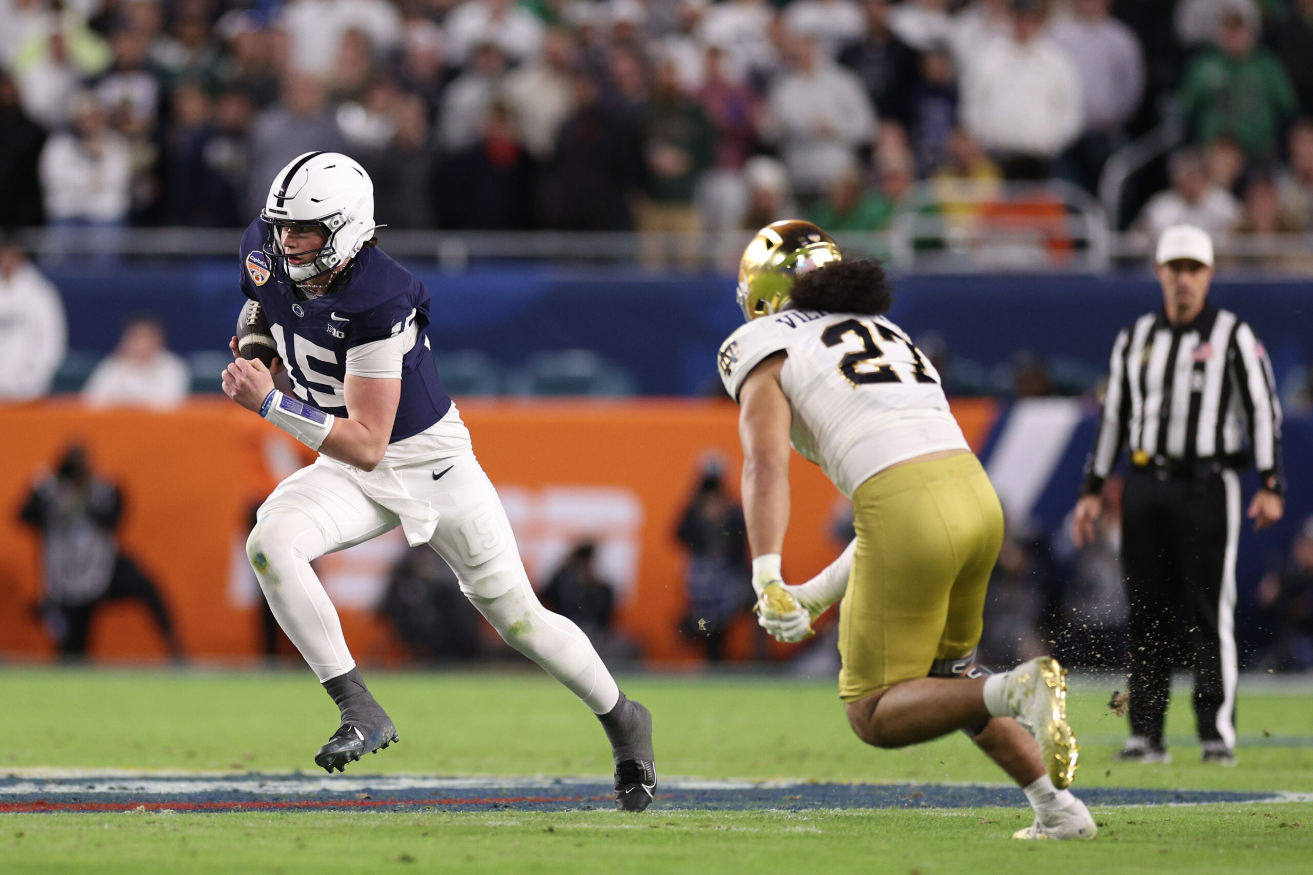 Jan 9, 2025; Miami, FL, USA; Penn State Nittany Lions quarterback Drew Allar (15) runs the ball in the second half against the Notre Dame Fighting Irish in the Orange Bowl at Hard Rock Stadium.