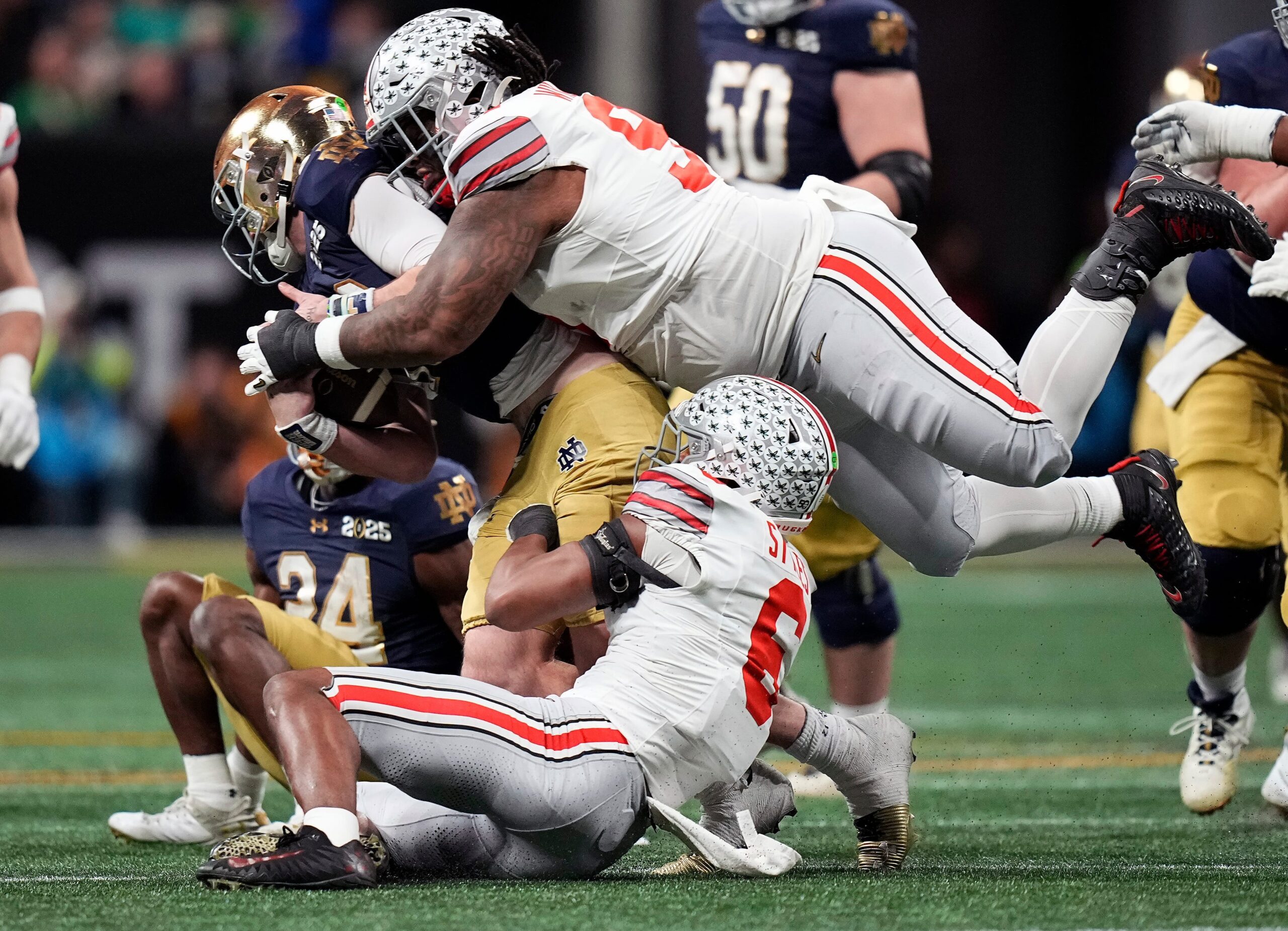 Ohio State Buckeyes safety Sonny Styles (6) and defensive tackle Tyleik Williams (91) sacks Notre Dame Fighting Irish quarterback Riley Leonard (13) in the third quarter during the College Football Playoff championship at Mercedes-Benz Stadium in Atlanta on January 20, 2025.