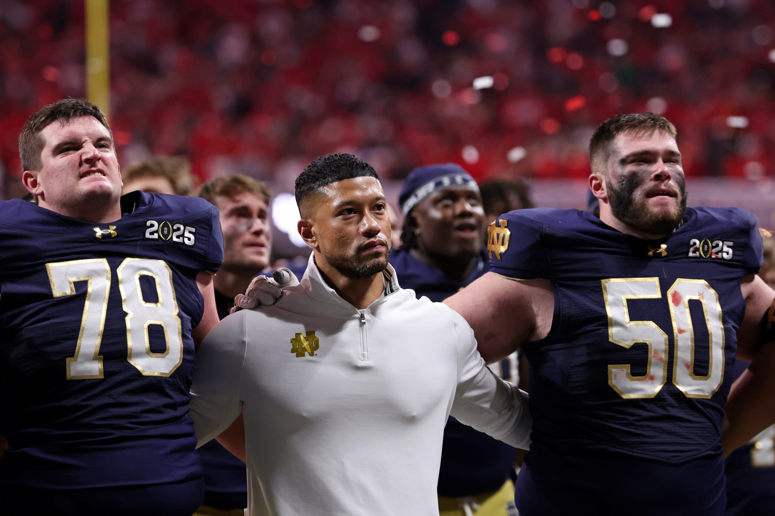 Jan 20, 2025; Atlanta, GA, USA; Notre Dame Fighting Irish offensive lineman Pat Coogan (78), head coach Marcus Freeman, and offensive lineman Rocco Spindler (50) react after losing against the Ohio State Buckeyes in the CFP National Championship college football game at Mercedes-Benz Stadium.