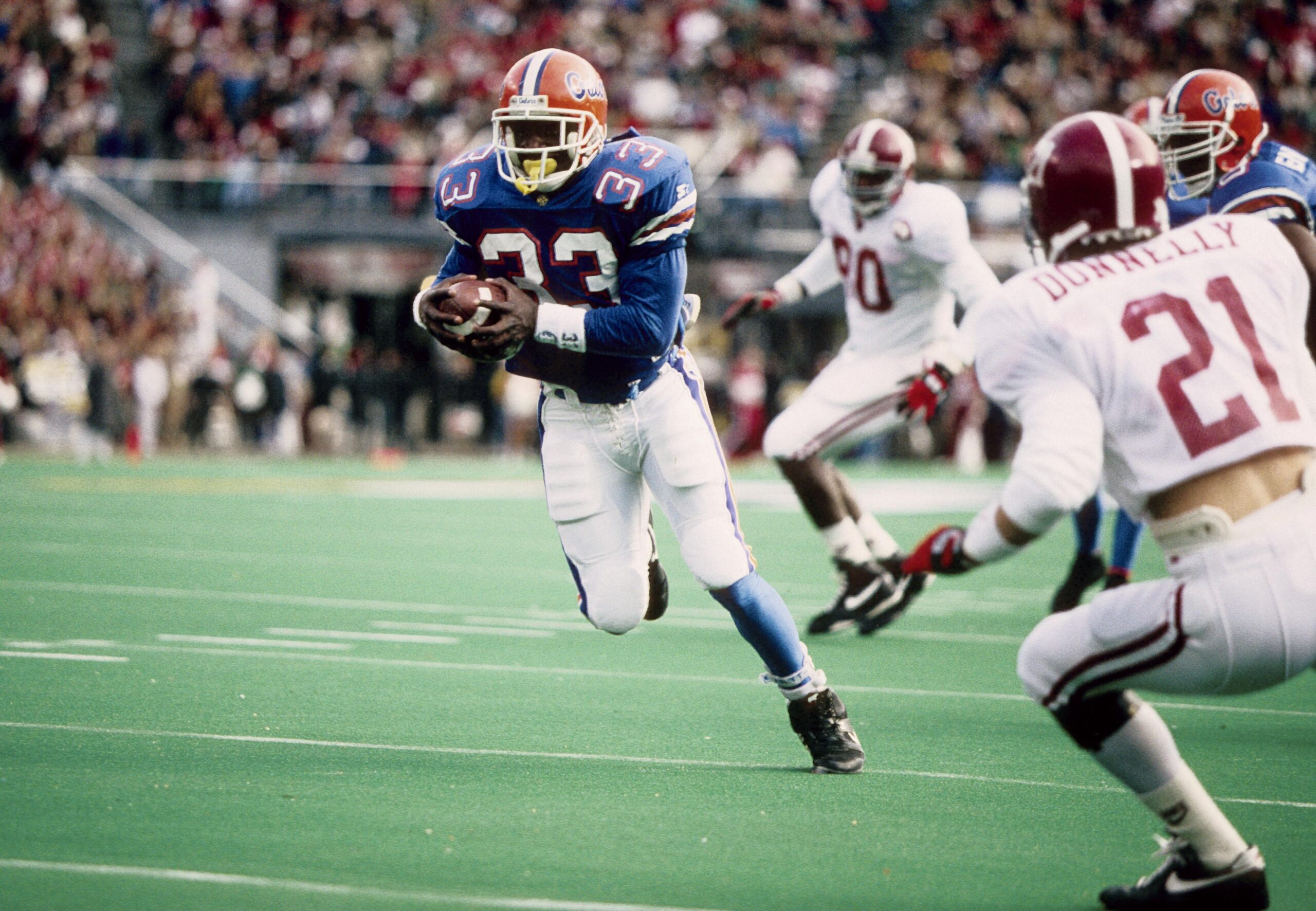 Dec 5 1992; Birmingham, AL, USA; FILE PHOTO; Florida Gators running back Errict Rhett (33) running the ball against the Alabama Ride Tide during the 1992 SEC Championship game at Legion Field. Alabama Crimson Tide beat the Florida Gators by a score of 28-21.