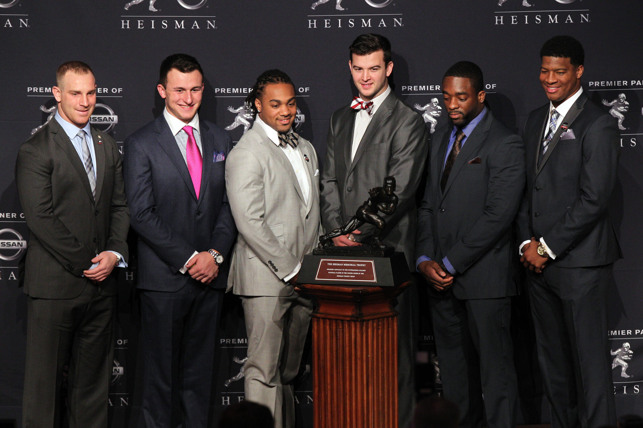 Dec 14, 2013; New York, NY, USA; (From left to right) Nothern Illinois Huskies quarterback Jordan Lynch, and Texas A&M Aggies quarterback Johnny Manziel, and Auburn Tigers running back Tre Mason, and Alabama Crimson Tide quarterback AJ McCarron, and Boston College Eagles running back Andre Williams, and Florida State Seminoles quarterback Jameis Winston pose for a photo during a press conference before the announcement of the 2013 Heisman Trophy winner at the New York Marriott Marquis Times Square in New York.