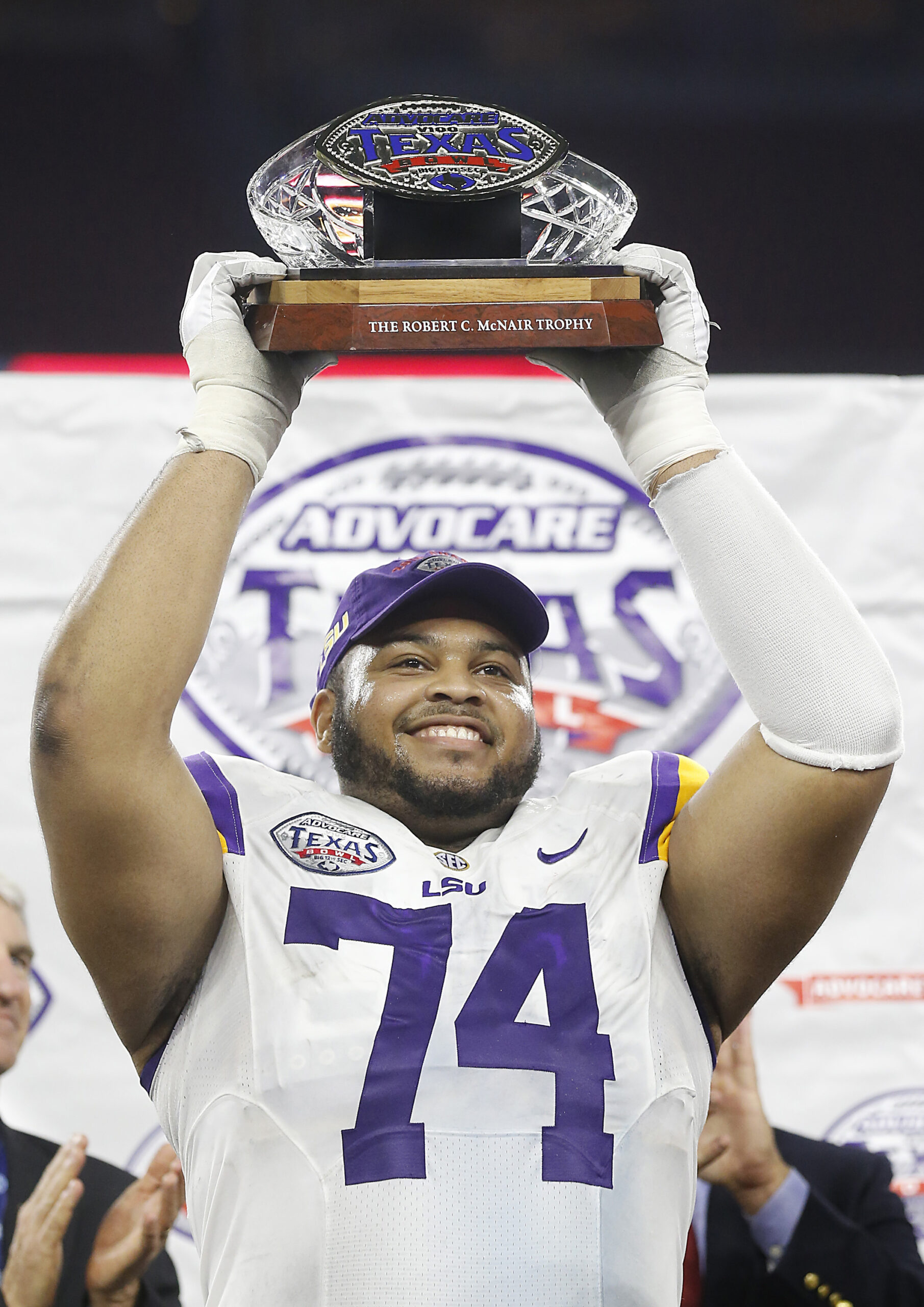 Dec 29, 2015; Houston, TX, USA; LSU Tigers offensive tackle Vadal Alexander (74) holds the Texas Bowl trophy after defeating the Texas Tech Red Raiders 56-27 at NRG Stadium.