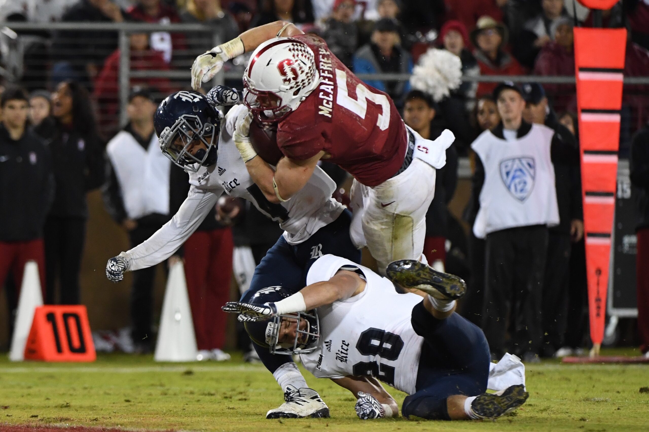 November 26, 2016; Stanford, CA, USA; Stanford Cardinal running back Christian McCaffrey (5) scores a touchdown against Rice Owls cornerback J.T. Blasingame (14) and safety Cole Thomas (28) during the second quarter at Stanford Stadium.