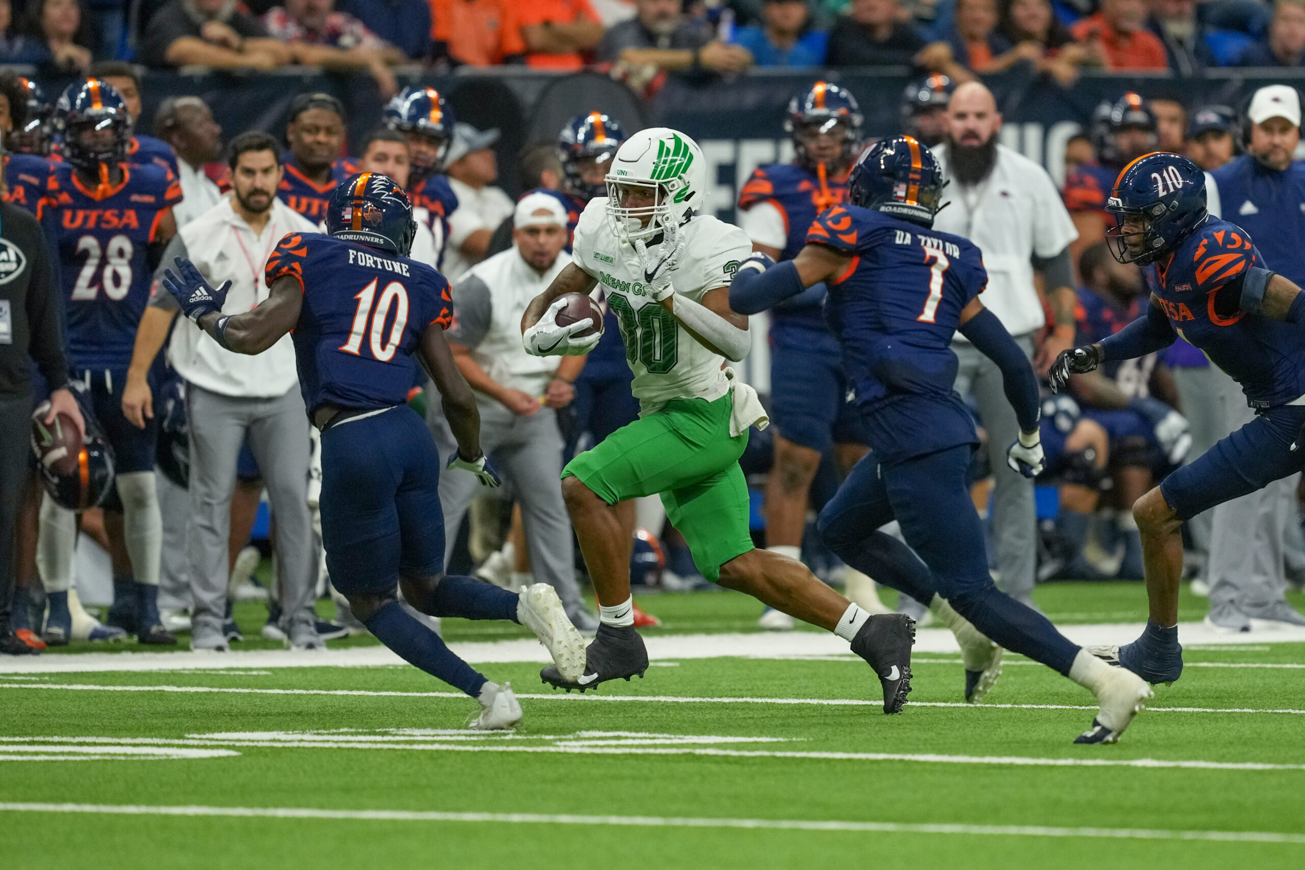 Dec 2, 2022; San Antonio, Texas, USA; North Texas Mean Green tight end Var'Keyes Gumms (30) runs the ball in front of UTSA Roadrunners cornerback Nicktroy Fortune (10) and linebacker Dadrian Taylor (7) in the first half at the Alamodome.