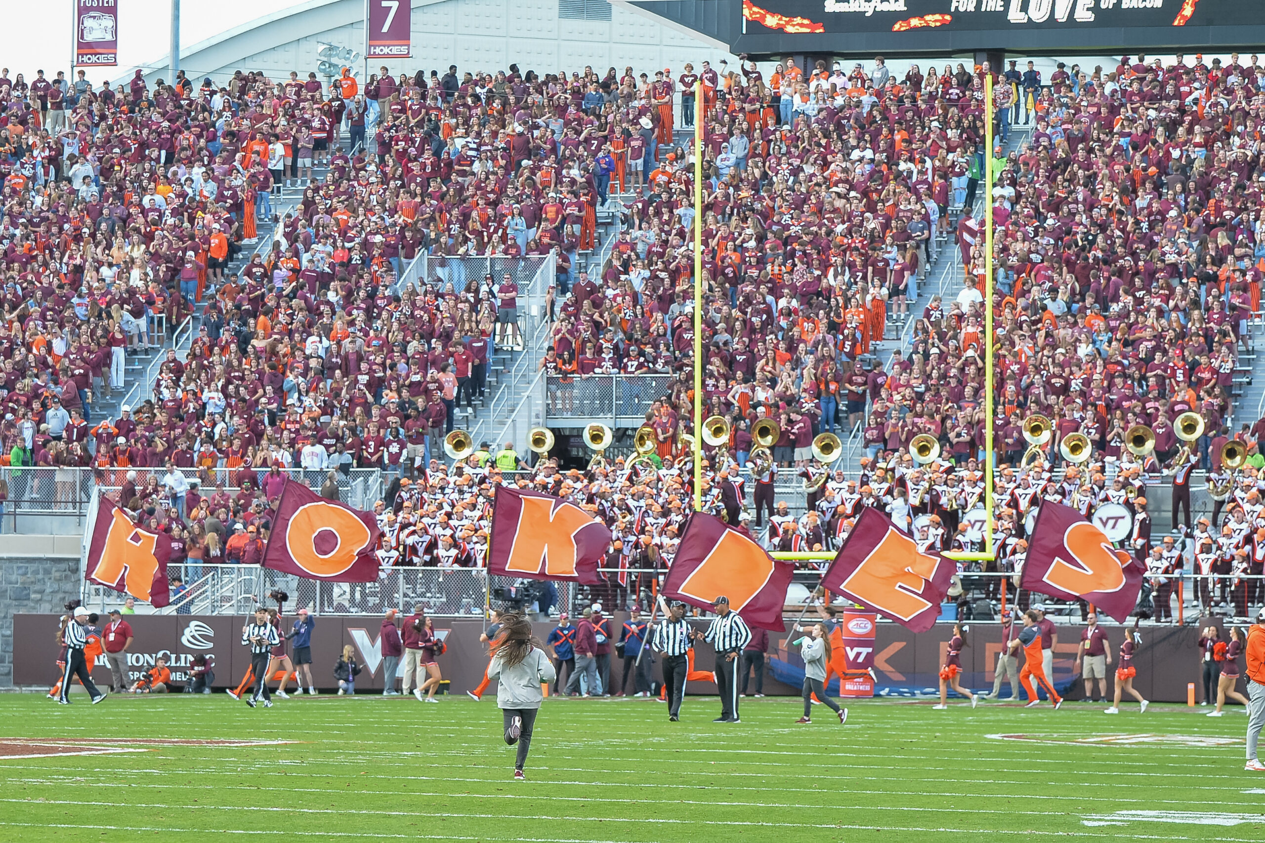 Sep 21, 2024; Blacksburg, Virginia, USA; Virginia Tech Hokies quarterback Kyron Drones (1) is pressed by Rutgers Scarlet Knights defensive back Desmond Igbinosun (4) during the second quarter at Lane Stadium.